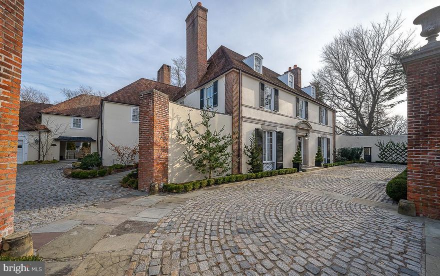 PRICE ADJUSTMENT ! Sylvan's Edge has been carefully restored to its original glory featuring the addition of many modern updates. Originally designed by noted Philadelphia architecture firm of Tilden, Register & Pepper for Joseph J. Greenberg. Sylvan Edge is a Georgian Revival Estate built in the late 1920s with attention to fine details and old-world craftsmanship, no expense was spared! Featured in Architectural Digest & listed in the Architectural Archives of the University of Pennsylvania. The entrance of the Estate features beautiful wrought iron gates, a walled Belgian blocked courtyard & professionally landscaped grounds. This Estate is situated on a stately flat corner lot of nearly 1 acre, a rare find in the area. Old world craftsmanship featured throughout: handcrafted Ludowici Clay Tile Roof (also on The Empire State Building, Yale University& Frank Lloyd Wright's Wingspread) adorns the oversized 3 car garage with loft. Through the marble entrance & impressive 2 story foyer soaring 20+ feet, you will find a library/office with wood burning fireplace, rich wood paneled walls, floor to ceiling built-in bookcases & one of the many spectacular chandeliers of the period. Step down into the grand living area with many French doors, high ceilings, custom marble fireplace , chandelier, walled carved paneled back wall with built-ins. You will spend hours overlooking the pool area and sunroom while enjoying the wood burning fireplace. The French doors open into the heated/air conditioned sunroom with an additional wall of French doors that overlook the spectacular grounds. Prepare to be stunned by the gorgeous travertine floors, Lunette fountain, and bar area which makes this home a great place to entertain before or after a swim in the heated pool to extend your seasonal use. There is an expansive new bluestone patio above the pool area extending from the French doors. Plenty of room for entertaining and year-round fun! Spacious formal Dining Room with floor to ceiling French doors, wood burning fireplace, and walls with hidden storage areas for glassware etc. Don’t miss the Gourmet Cook’s Kitchen with high end appliances including an 8 Burner VIKING Range, original restored range hood, additional full oven, 3 sinks, 2 dishwashers, microwave, full size freezer, and separate full-sized refrigerator! No expense was spared with this carefully planned designer kitchen with its Quartz Countertops and Farmhouse Sink. Adjoining first floor laundry room with covered exit to the courtyard. Don’t miss the  staircase to the back bedrooms on the 2nd floor. First floor powder room tucked away between the foyer and kitchen/dining room area with its Mercer Tile floor and custom design features. Travel up to the second floor where you will find a Primary Suite suited for royalty. Relax by the fireplace and enjoy the custom painting and built-ins in the extra-large Primary Bedroom. Adjoining dressing room features custom closets, a bathroom with soaking tub, marble top custom hand-painted cabinetry, fresco designs, a custom sink, and crystal style faucets. There is an additional shoe closet/shelving with leaded glass designed doors ,adjoining bathroom with shower and tub and another dressing room. You will never want to leave the bedroom!  A  charming Veranda overlooks the pool and rear grounds. The second bedroom on this level features another ensuite large walk-in closet and fireplace with custom tile. You  willfind 3 additional bedrooms with plenty of closet space in each room and in the hallways, and 2 full bathrooms. Third floor features 3 additional bedrooms and a full bathroom. There is a very large unfinished basement with high ceilings, upgraded electric and new heating (3 Zones) and high velocity air conditioning system. Too many details to list! Close commute to Center City, Chestnut Hill, 309 and Turnpike. Walk to the train and the many shops and restaurants of Elkins Park.