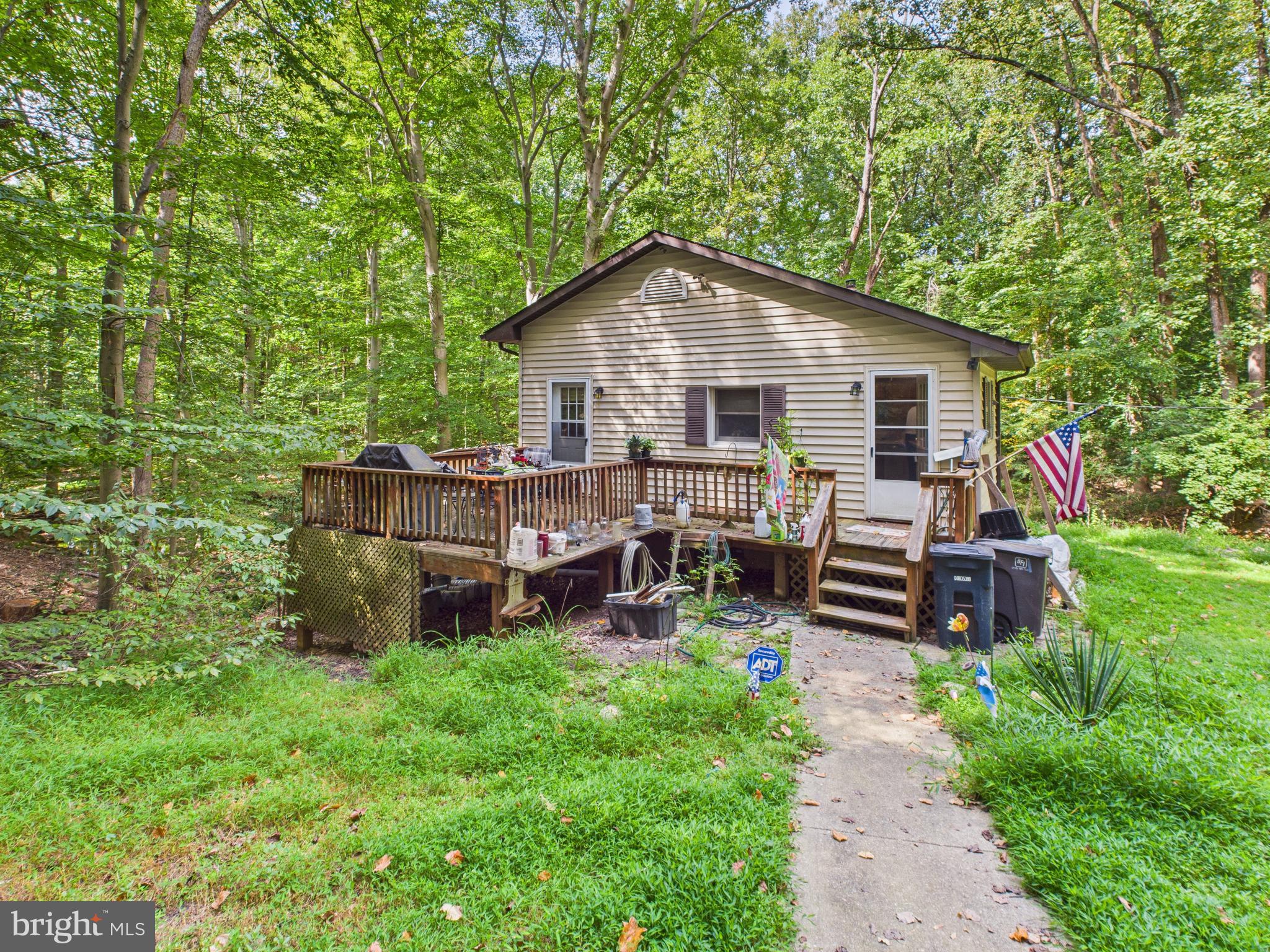 Single family home with 2 bedrooms and 1 full bath on an acre lot in Laurel. This property will fully immerse you in nature. Home structure is made of cinder block providing great bones to make it your own. Home stays cool in the summer with the cover of beautiful trees and plenty warm in the winter with wood stove. Basement is unfinished, provides plenty of storage and laundry area along with outdoor access. Location is close to commuter roadways, shopping, grocery, parks, schools, and much more!
