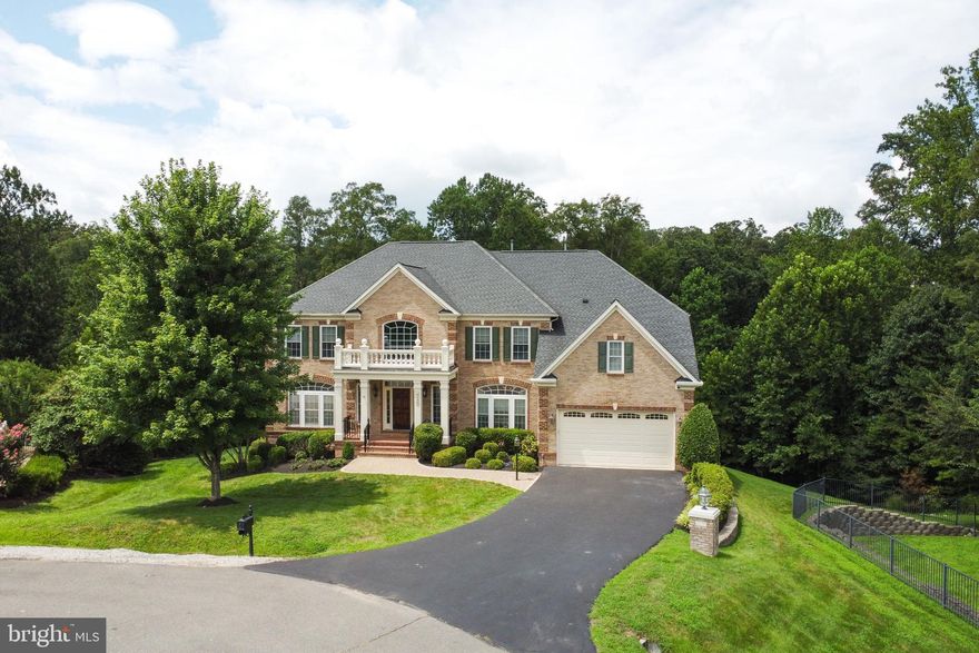 **Multiples offers received** Welcome to 9336 Elkhorne Run Ct, an exceptionally well cared for, 5 bedroom, 5.5 baths, tucked away in a quiet cul-de-sac!  Come be a part of the elegant estate community of Occoquan Overlook! This exceptional NV Home, Monticello model, is sitting on nearly a .84 acre lot, with over 7,000 square feet of finished space on three luxurious levels!  A freshly, fully painted exterior and brick facade greet you, boasting accent quoins and keystones   As you step inside you are met with a grand two-story foyer, gleaming hardwood floors and  dual staircases!  A majestic main level with all the architectural accents and accoutrements, bursting with natural light from the spectacular, custom Palladian windows will captivate you! Venture into the grand family room with 18 ft high coffered ceilings and built in recessed lighting, gas fireplace and built in entertainment center   The formal dining room features hardwood floors, custom accent moldings   Recent upgrades highlight the spacious kitchen , custom cabinets are 10 years old, granite countertops, newer stainless steel appliances, large center island, custom 18' Italian tile flooring , generous,  sunlit breakfast area with full view and walk out to deck overlooking a portion of the Occoquan National Regional Forest. Don't miss the professional office , large mud room and laundry room at the garage entrance.  As you meander upstairs, you are presented with four spacious bedrooms all 9ft Ceilings , each with its own private full bath! The grand two story overlook leads you to a grand primary suite, featuring a sitting room, tray ceilings, enormous dual closets and spa like primary luxury bath. The main level and bedroom level has brand new luxury pile carpet and padding The whole family will enjoy the fully finished basement, complete with large re-room, walk out to rear patio, accessorized wet bar area, a grand media room with all the trimmings, loads of storage space, bonus office or guest room   full bath and  5th bedroom! The whole house setting is peaceful and secluded,  and the large low-maintenance material deck is over 300 sq ft of fun space for family on gorgeous summer days & night! also featuring walk down stairs to rear patio! All of this tucked away in private setting but yet a commuters dream! Minutes to the Fairfax County Parkway, I-395, and 10 minutes to the Lorton town center with the Virginia Railway Express station. Elegance and convenience as well as a sought after public school  pyramid. Lastly this has a 2.25% assumable VA    Come see this meticulously cared for gem! Floorplans attached & 3D tour is available. !!  Sunday @ 1-4pm.