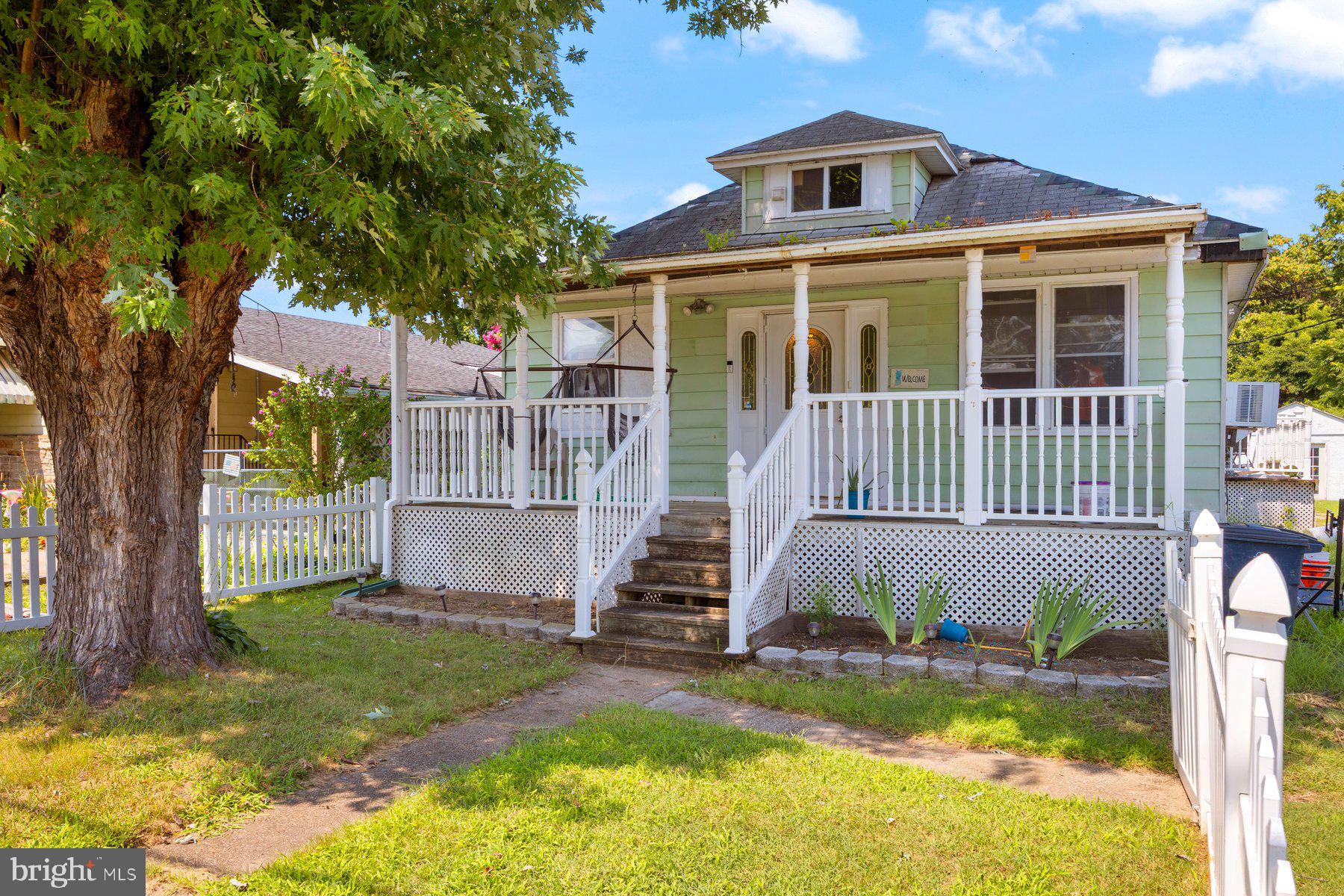 Adorable, 2BR/2BA Cottage located on a spacious lot in the quiet neighborhood in Essex. Make your way through the picket fenced yard past a lush green lawn with an adult shade tree, on the way to the spacious covered front porch into your new home. Step inside a home filled with natural light, easy care flooring and a soft color palette. The main living spaces consist of a large living room, dining room and kitchen. The kitchen features plenty of cabinets and counter space, stainless steel appliances, and a deep porcelain sink under a window. Just past the dining room is an enclosed porch offering an ideal space for a home office. Down the hall is a spacious secondary bedroom with a private full bath and laundry, and a spacious primary bedroom featuring a private en suite offering a large walk-in shower with a built-in bench and a deep jetted soaking tub. From the dining room step outside to a spacious wood deck that overlooks a yard filled with green space, a large shed, and so many possibilities. This home is ideal for any new homeowner and is located in close proximity to shopping, restaurants, and commuter routes.