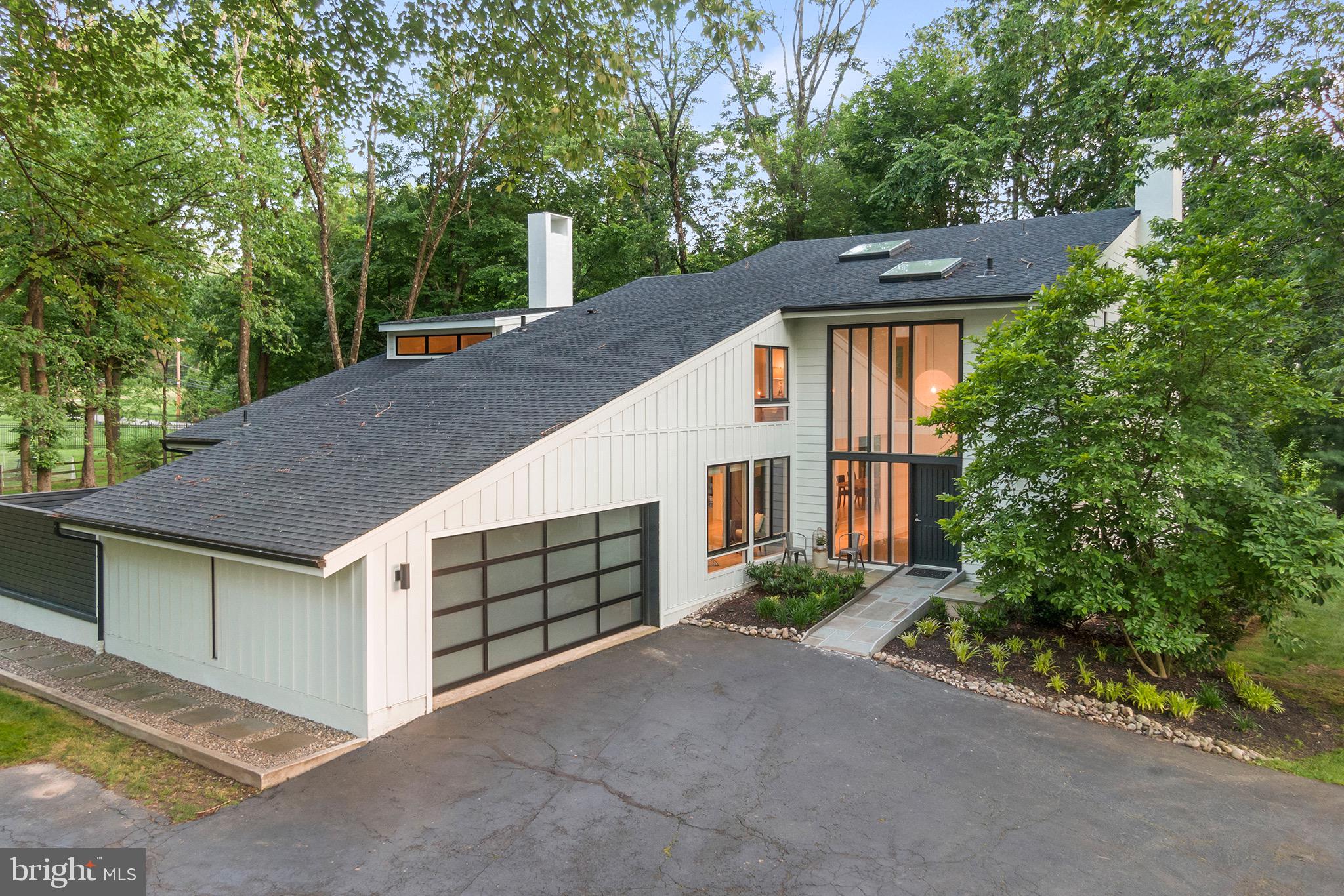 Located at the end of a cul-de-sac in the heart of the Mainline, this magnificent 5 bed/3.5 2 story home is situated on a flat, 1acre private lot in the nationally acclaimed Lower Merion School District. Meticulously renovated in 2016 the home boasts 2 en-suite bedrooms, one of which is located on the main floor, open plan living, abundant natural light through Pella windows and various skylights, new roof and HardiPlank Board and Batten facade installed in 2019, a security system and superior Internet/WiFi service. All rooms feature clean lines, wonderful views of the property and either Jasper white French 6 inch plank hardwood or slate floors. Closets are large and have custom Elfa storage systems. A welcoming foyer, which is open to the upper level, provides access to the living room, study/den/playroom, laundry and mudroom, powder room and gourmet kitchen. The carefully planned kitchen will wow you with its sleek white Wellborn cabinetry, ample storage, stainless steel appliances (Subzero refrigerator, induction cooktop with overhead Thermador hood, Bosch dishwasher, wall oven & microwave) and spectacular center island composed of Caesar stone quartz and Walnut. This space is further enhanced by the beautiful, spacious deck which extends the full length of the back of the house. Perhaps one of the best assets of this property is the large main floor bedroom with a generous walk-in closet, a wall of floor-to-ceiling walnut cabinets and a stunning spacious bathroom with roll-in shower, 2 floating vanities, slate flooring and beautiful tile work. This lovely bedroom also has its own deck plus access to a very private patio. Ascending the wood and glass floating staircase you will find 3 more bedrooms which share a hallway bath, complete with soaking bath tub and dedicated shower, and the 2nd en-suite bedroom. This room has its own wet bar with mini-sink, and bathroom with slate floor, stall shower and 2 floating vanities. The basement has been partially finished with slate flooring. One area is currently used as a gym. The other space is ideal for TV room/play room/art room/office. The unfinished portion of the basement houses 2 water heaters, a state of the art Wi-Fi system, 2 AC units and wonderful storage. From its understated elegance to its attention to detail this home will not disappoint! Convenient to all major highways and the Mainline train system this property really does have it all!