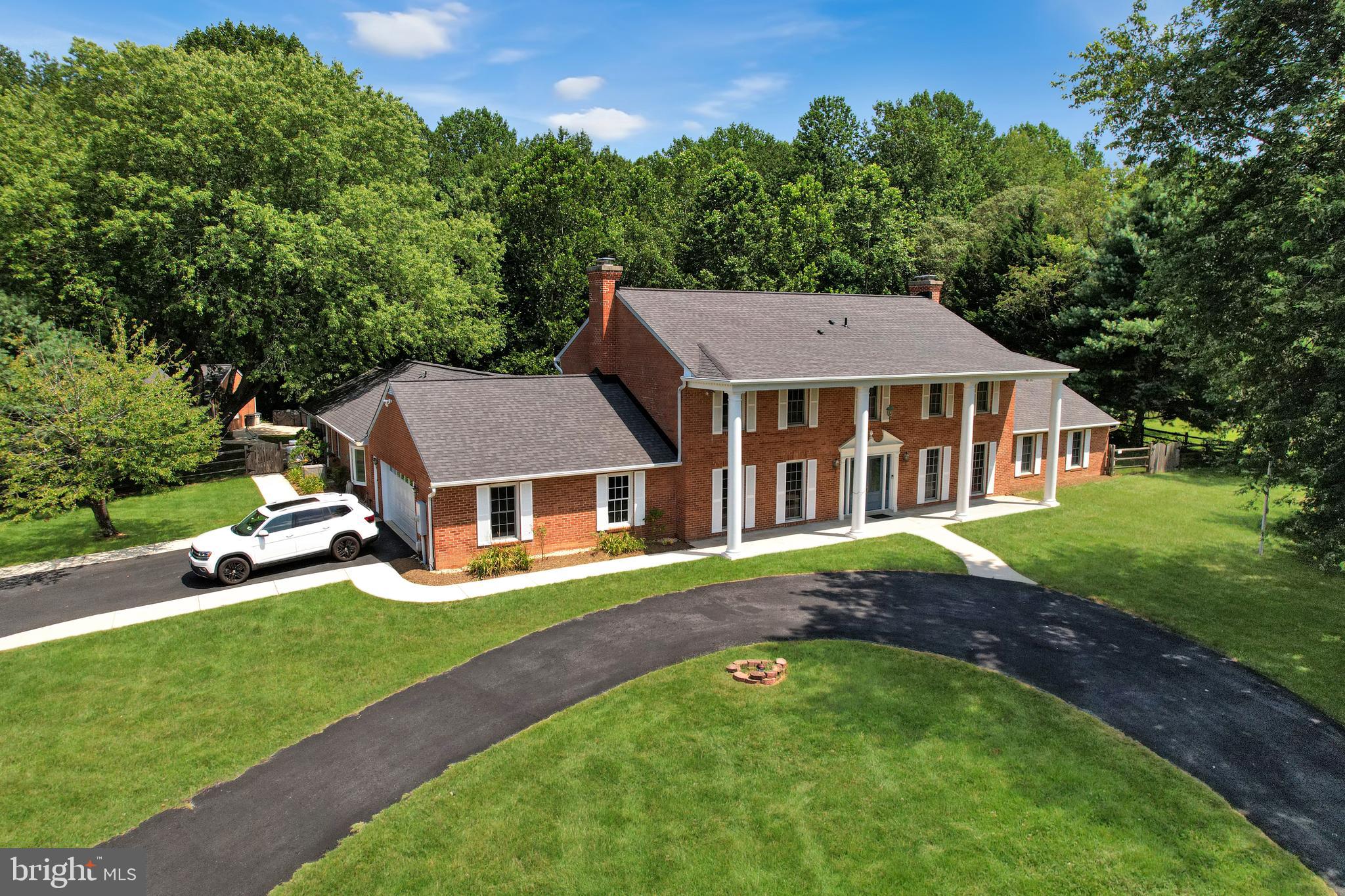 Custom Built, ALL BRICK Colonial on a secluded cul-de-sac with nearly 5000 finished square feet of living space, attached 2-car garage, in addition to a 4-car detached garage with it's own LP Gas Heat and central A/C, in-ground pool, firepit and covered outdoor kitchen. This home also has an attached In-Law Suite with its own separate full kitchen. There are 5 total Bedrooms and 4.5 total baths, new carpet (just installed - Aug '25), there is a large In-Ground pool surrounded by an expanded ('21) walk-around concrete patio with ample chair/table space, a covered rear patio with outdoor kitchen cabinets, countertop, two "dorm" size refrigerators, and an outdoor sink. There is a private nature tr ail (thru the rear fence walk-thru gate at the right/rear of the fenced yard) with a tranquil wooded sitting area all situated on a 3+ acre lot. Some other capital improvements/recent updates included: all roofing has been replaced with architectural shingle roofing ('24), added two geo-thermal HVAC systems ('16) and these central A/C and heating units each have dual zones, renovated both upper level full baths and the oversized large bath in the in-law apartment (providing direct access to and from the pool area). The owners also added LVP flooring and recessed lighting in the dining room and LVP flooring in the main level office, they added concrete walkways to the in-law apartment and the rear yard ('21), replaced the home's front (formerly wood) columns with composite/fiberglass material ('16), fully resurfaced the blacktop circular drive ('17), added rear yard timer-activated accent lighting ('22). All overhead garage doors were replaced this year ('25), the downspouts have been routed under the rear sidewalks, and blown-in insulation was added to all attic areas ('22). Anderson windows and doors, mini-split HVAC in the Great Room, there are pictures galore for you to view, and make sure you look at the (1st and 2nd floor) floorplans and the exterior (drone) pictures!