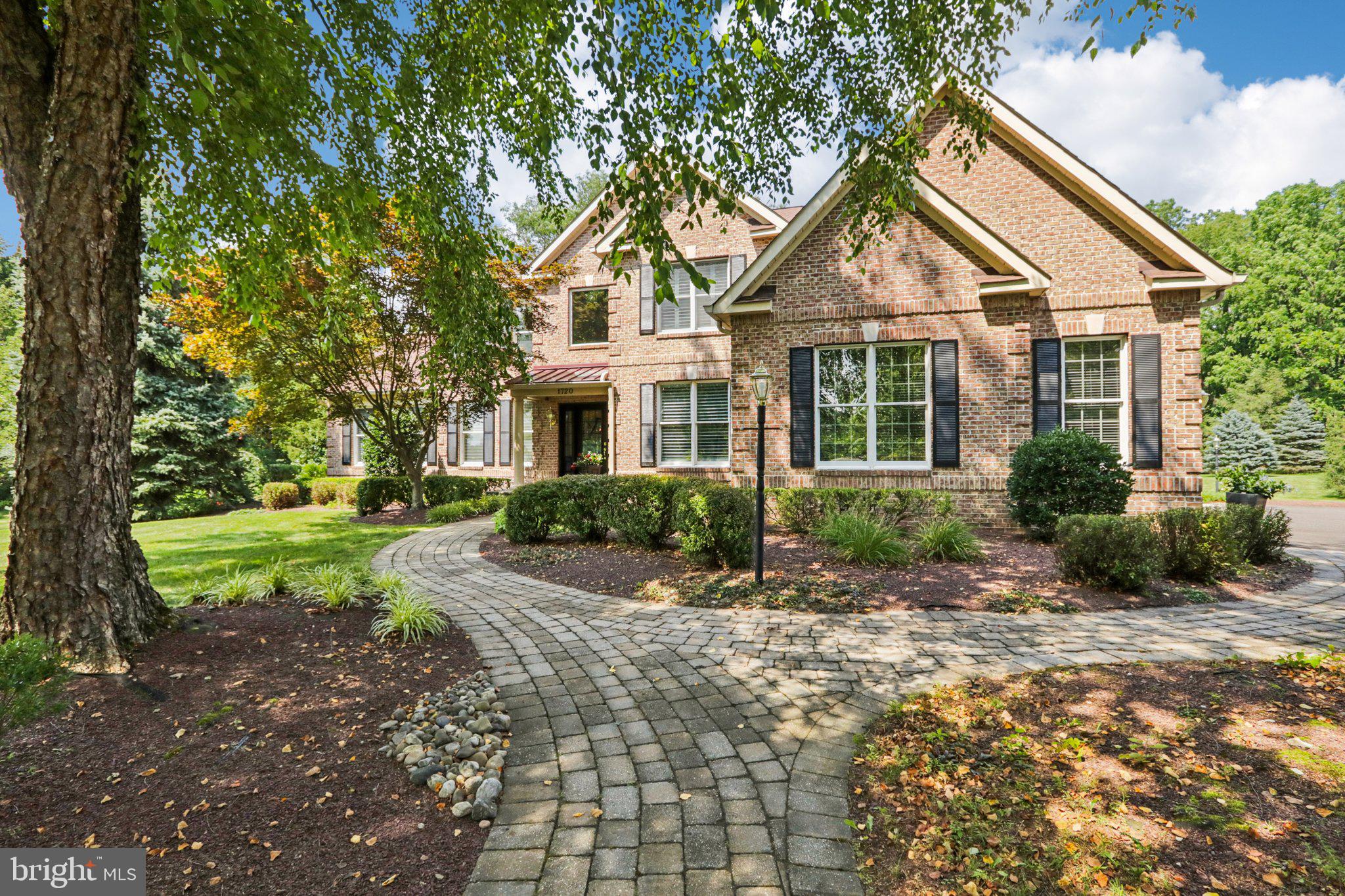 First Time Offered! Welcome to this exceptional 4-bedroom, 3.5-bath home nestled in the charming community of Devonshire Estates. Set within a picturesque enclave of homes, this stunning residence combines timeless elegance with premium upgrades throughout. A custom-designed paver walkway and lush professional landscaping lead to the front door with sidelights, setting the tone for the refined interior that awaits. Inside, a grand two-story foyer opens to a flowing floor plan filled with natural light and thoughtfully curated details. Rich hardwood flooring run throughout most of the home, complemented by high-end finishes and architectural accents. The gourmet kitchen is a chef’s dream, thoughtfully designed featuring Wolf and Sub-Zero appliances, Sub Zero wine cooler, 2 Bosch dishwashers, luxury cabinetry, and a sun-filled morning room—perfect for everyday dining. Adjacent is the expansive two-story family room with a fireplace, custom built-ins, heated floors and a full wall of windows framing views of the private backyard. Entertain effortlessly in the elegant living and dining rooms, the latter featuring custom built-ins, or unwind in the sunlit conservatory complete with a wet bar. Upstairs, the luxurious primary suite offers a serene retreat with a sitting area, oversized walk-in closet with custom built-ins, and a completely renovated spa-like bath featuring an oversized walk-in shower with a seat, custom double vanity, and sophisticated finishes. Three additional bedrooms include an en-suite and a Jack-and-Jill bath, offering both privacy and convenience. Additional highlights include a 3-car garage, a dog wash, custom built-ins, full basement, extensive hardscaping with patios ideal for outdoor entertaining with a built-in Viking grill, and a beautifully landscaped yard framed by tall trees for privacy. This meticulously maintained home offers the perfect blend of luxury, comfort, and style. Close to shopping, highways, schools, theater, restaurants, and the amazing and charming downtown Yardley. Make your appointment today. Don’t miss this incredible opportunity!