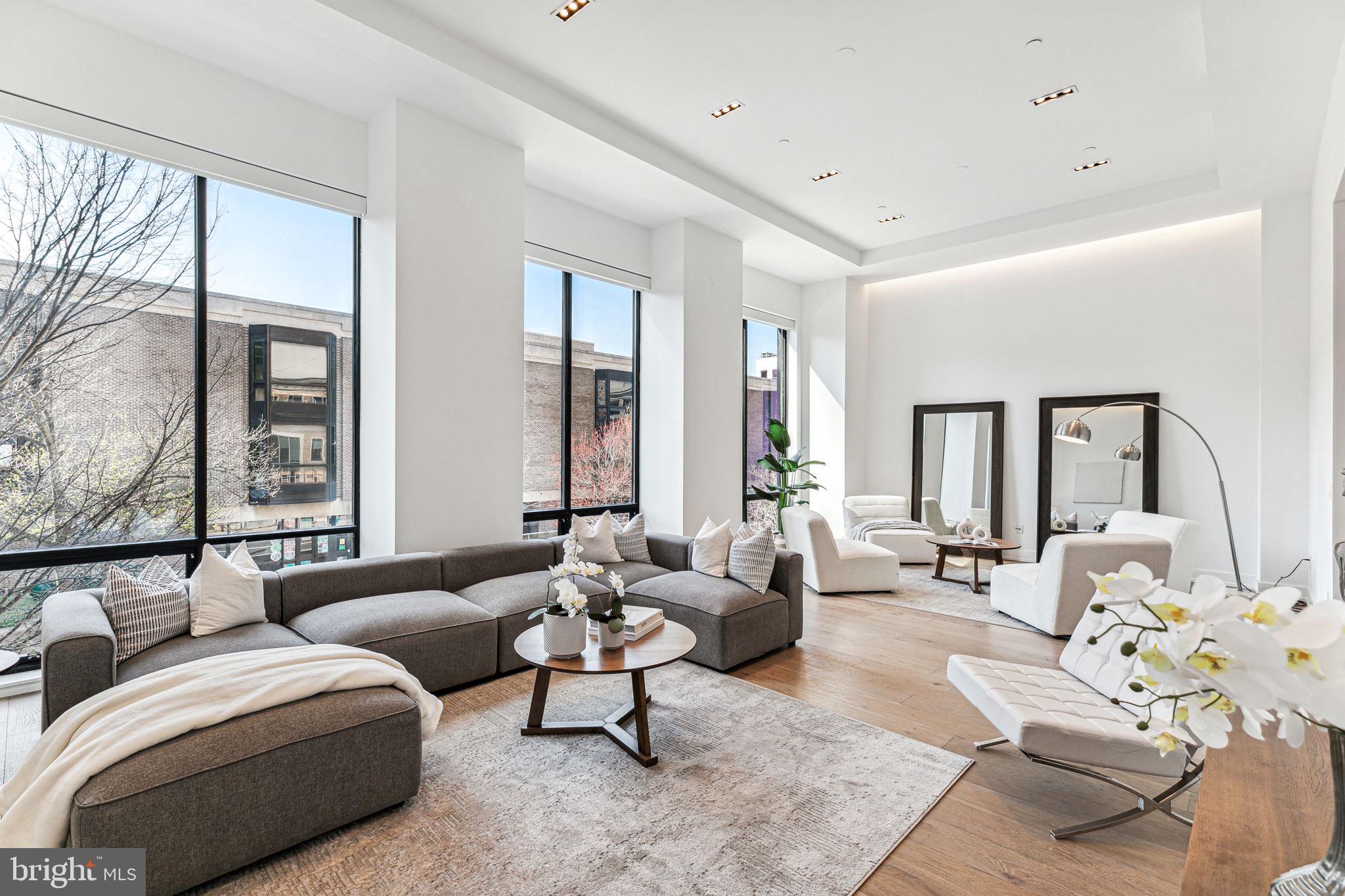Designed for the resident who values discretion, simplicity & high-end living, this full-floor new construction condominium by Astoban Investment Group spans 3300 sf and features 3 bedrooms + den, 3.5 bathrooms, a private patio, attached garage parking, and a separate storage room. The elevator door opens to a private vestibule exclusively for Unit 2. Once inside the residence, you will notice the high ceilings - over 12 ft+ - and natural light from the south-facing windows that line the expansive living room. These oversized windows are outfitted with motorized shades and provide a lovely view of the neighboring buildings. The size of this room, coupled with the high ceilings and floor-to-ceiling windows create that wow factor the moment you enter. Adjacent to the living room is an intimate den - perfect for a library, home office, formal dining room or media room. The kitchen is a cook's dream with custom cabinetry, a grand island, quartz countertops, and a suite of high-end appliances which include the vented Wolf stove with 6 burners plus a griddle and 2 ovens, 48'' Sub-Zero Refrigerator, built-in coffee/espresso cafe, and a 36'' beverage/wine chiller. This eat-in space is ideal for both cooking and welcoming guests and is adjacent to a powder room and a private patio with plenty of room for outdoor dining and lounging. The primary bedroom suite is complete with a customized walk-in closet and a lavish en-suite bathroom which features a double vanity sink with stone counters, an expansive seamless glass shower, soaking tub, and a separate water closet. Two additional spacious bedrooms are just down the hall and each includes an en-suite bathroom. This unit is complete with a laundry room and additional storage closets throughout. 2207 Chestnut Street is an exclusive boutique building with 4 full-floor condominums. This premier location is in close proximity to the Schuylkill River trail for running, walking, and biking, Traders Joes, Whole Foods, 30th Street Station, Penn, CHOP, Drexel, Fitler Club, and some of the best restaurants and retail the city has to offer. Also in the Greenfield School catchment. LOW MONTHLY FEES AND TAX ABATEMENT.