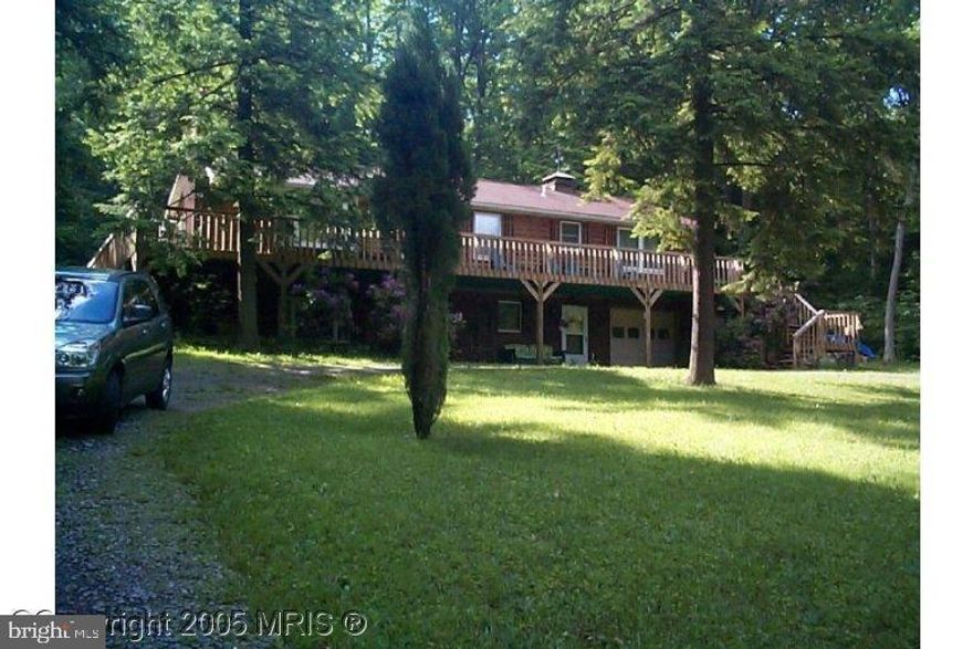 Lake access-1/12 interest in 100ft. Lakefront lot across the street.  As-Is- needs lots of work. Gorgeous level lot.Would make great rental- 2 separate units with  separate meters.  This 4 bedroom, 3 bath- 3 bedrooms, 2 baths upstairs.  1 bedroom living room and kitchen in lower level.-Fireplace up stairs, vaulted ceilings and  wood insert in family room downstairs. Cedar siding home with deck cross front and part of back. separated deed tax parcel included. SOLD STRICTLY AS-IS.  SELLER WILL MAKE NO REPAIRS