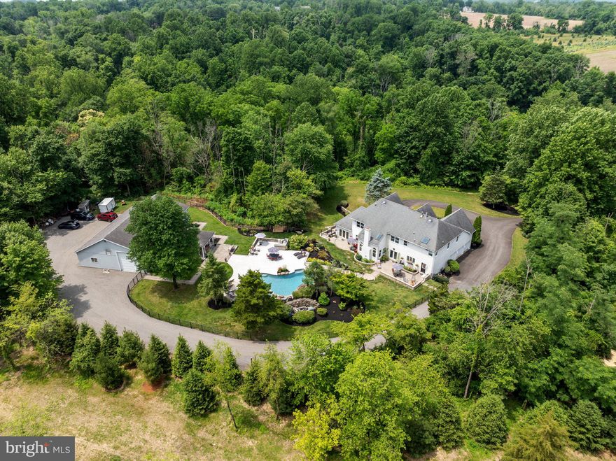 Own your personal resort! Searching for your primary home or vacation spot in beautiful Bucks County, you deserve to consider ”THE BUCKS COUNTY RESORT,” as the seller affectionately calls it. This SPECTACULAR CUSTOM-BUILT HOME, LOCATED ON 6.14 ACRES, offers over 6,000 sf of living space, a resort-style heated in-ground pool and spa, Cabana, 5-bay, detached garage & is surrounded w/ professionally designed landscaping & hardscaping. Just minutes to Newtown, Wrightstown, the center of Richboro & close to all major routes & many Bucks County attractions, this property is located w/in the Council Rock school district (CR NORTH HIGH SCHOOL). / / Offering 5 Bedrooms (4 upstairs & room for 1 in the basement). 5.5 full bathrooms & a fully finished Basement, the home is set back 700 ft from the road for ultimate privacy. / /  The entrance sets the stage w/ a 2-story grand foyer. On 1st floor: formal Dining Room; Kitchen w/ walk-in pantry; 2-story Family Room w/ wood-burning fireplace, skylights & beautiful views; Home Office with built-ins; Living Room; Sunroom, w/ a wall of windows to bring the beauty of the outside in & a tropical-themed mural (parrots included for your enjoyment); Powder Room; Mud Room; access to the oversized 3-car attached garage & doors to the backyard patios.  / / The imperial staircase leads to the 2nd floor, with views from the princess balcony, a second staircase to the Kitchen & access to 4 Bedrooms. / / The PRIMARY SUITE, WITH SITTING ROOM & 3-SIDED GAS FIREPLACE, features a tray ceiling w/ overhead mounted TV (included), 3 walk-in closets w/ 1 that is a perfect dressing room, & stairs to a full-size unfinished attic. The PRIMARY BATHROOM has a cathedral ceiling & skylight, dual sinks w/ new lighting & faucets, private water closet, JACUZZI TUB & shower stall. Bedroom 2 is a PRINCESS SUITE w/ full bathroom, walk-in closet & offers amazing views. Bedrooms 3 & 4 are spacious & share the Jack and Jill Bathroom w/ dual sinks & a tub/shower combo. / /  The FULLY-FINISHED WALK-OUT BASEMENT is an additional level of living space & is unlike any other basement you have seen! Read while sitting by the wood-burning fireplace, binge the latest streaming series or GATHER YOUR FRIENDS AROUND THE FULL BAR, where the glass is always (at least) half full. Serve up cold brews w/ your kegerator & custom Harley Davidson beer tap. The bar includes down-lighting, 2 brass sinks, locked liquor cabinets, mirrored wall w/ shelves & a pocket-door to the KITCHENETTE w/ sink, refrigerator, dishwasher & pantry. This is ideal when entertaining to prep food, store snacks & bar ware - close the door so everything is out of sight. / / Shoot pool in the BILLIARDS ROOM, workout in the EXERCISE ROOM then head to the SPA ROOM to meditate, use the SAUNA or take a STEAM SHOWER. Savor your favorite bottle in the temperature-controlled WINE ROOM, head outside to the patio & enjoy your peaceful surroundings. / /  The highlight of this property is the BREATHTAKING OUTDOOR RESORT GROUNDS! Walk from any of the gorgeous patios up a few stairs to the big reveal - the HEATED IN-GROUND POOL WITH ROCK WATERFALL AND SPA. Swim then enjoy the jets in the spa as they remove any remnants of stress. With vast backyard patio space, you can host the grandest of parties. The BBQ patio area has a built-in gas grill & side burner. Your CABANA (680 sf) offers shade on the patio, tropical vibes, wet bar & a full bathroom around the corner. / / The 2,356 SF 5-BAY DETACHED GARAGE is hand-crafted w/ knotty pine interior, has commercial fans & lighting & has epoxy floors. Use the space for indoor sports (pickleball anyone?), working on cars (plenty of room for a lift), a workshop, or storing all your resort toys - even a boat - since the 5TH BAY IS EXTRA TALL. / / The list of amenities continues! Wander over to the NATURE TRAILS, take a leisurely walk or go crazy on your ATVs. >> Life is short, buy the house!<<