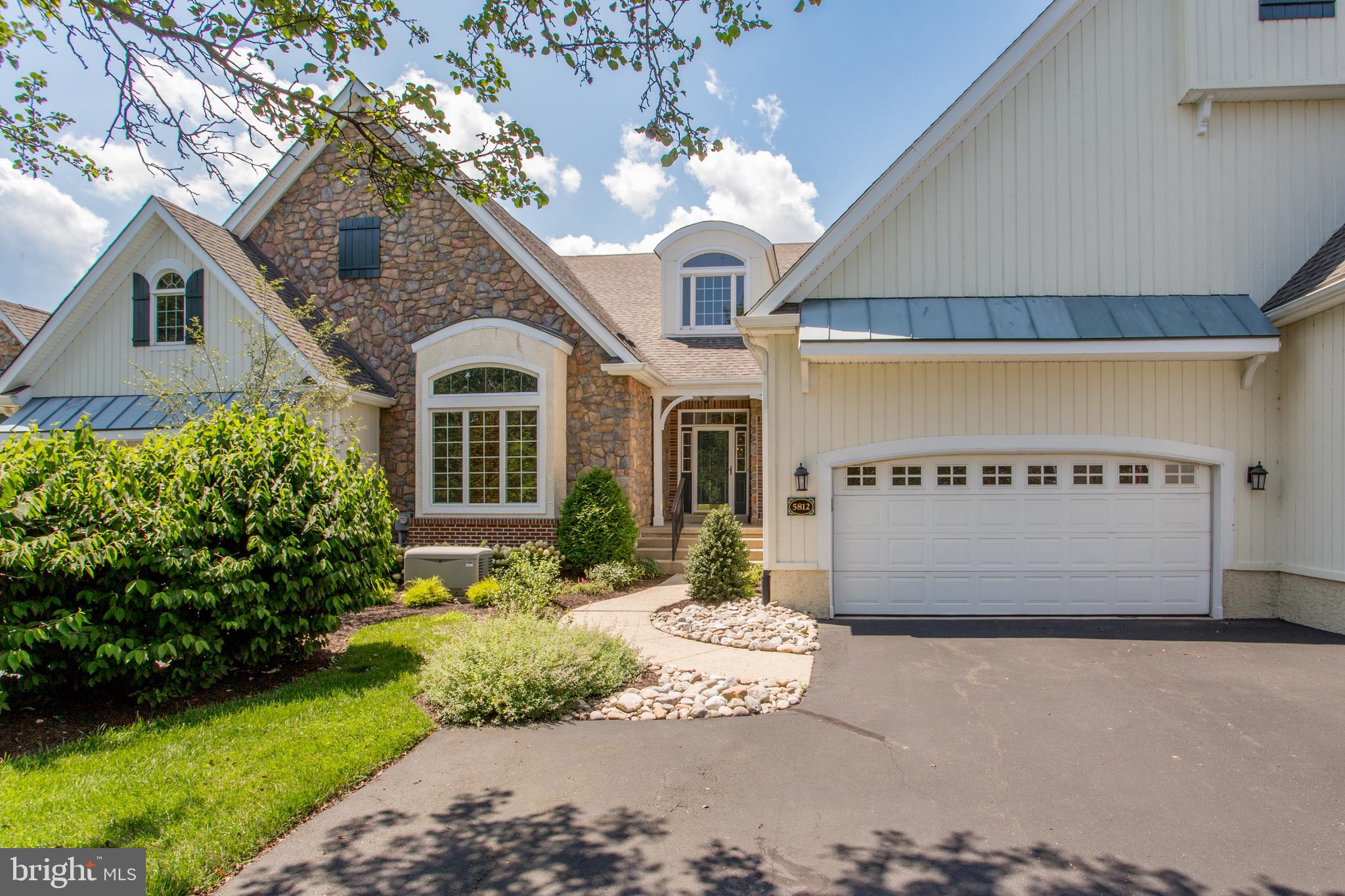 Experience living in the ultimate Bucks County condominium community Stone Ridge. With only 30 units in the this De Luca built townhouse community this Brierdale Model has over 5200 sq ft of living space on two levels. Available for the first time in 22 years. Entering a dramatic 21 ft high foyer, you see the open staircase leading to the finished lower level and living room beyond, office/bedroom with a cathedral ceiling to the left, remodeled bath and large dining room to the right. The spacious rooms have 9 or 12 foot ceilings throughout. The foyer, dining room, kitchen and breakfast area have hardwood flooring. A cook’s kitchen opens into the breakfast room with doors to the awning covered Trex deck and living room with gas fireplace. GE Profile appliance in the kitchen include a natural gas cook top, wall oven and microwave, dishwasher and side by side Refrigerator. Steps away is a pantry and access to the two-car garage with a convenient lift installed and stairway to the lower level. The location is ideal with views of deed restricted land behind. The primary bedroom is on the main level with a beautifully updated bath and two large walk in closets.
The lower level has high ceilings and a totally open room with wet bar and built in bookcases. A lower level bedroom and bath and the large entertainment room both open to beautifully installed paver patios. An additional room for hobbies or an exercise room leads directly to the stairway to the garage and large utility storage room. An automatic natural gas generator has been installed for emergency power.
With a close proximity to Peddler’s Village, there are direct paved pathways to be able to enjoy the festivals, restaurants, holiday lights and stores that are available .
This home has a one year America's Preferred Home Warranty