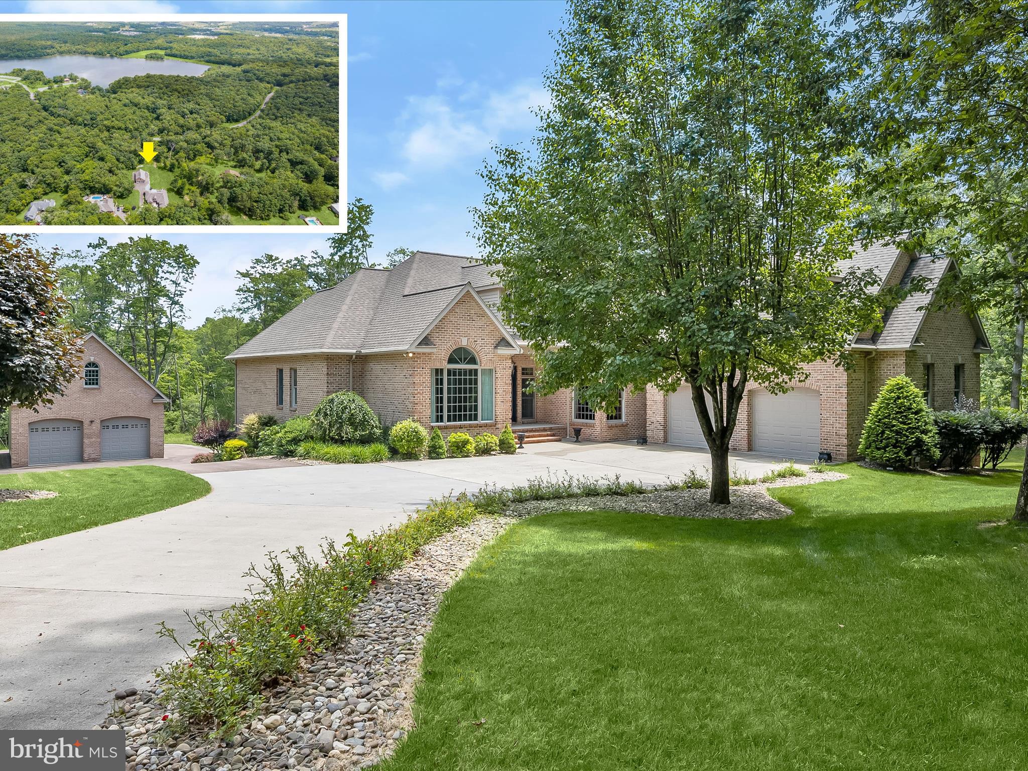 Set on a serene 2.4-acre wooded lot, this thoughtfully crafted Southern-inspired property offers exceptional privacy while placing you minutes from the region’s most popular destinations—including Deep Creek Lake, Wisp Resort, Broadford Lake Park, and everyday essentials like shopping and medical care. Built to accommodate both relaxation and entertaining on a grand scale, the home offers 5 spacious bedrooms, 4 full baths with custom tilework, and 2 additional half baths. The main garage provides direct access to the house, while a separate 28x48 utility-equipped garage with tall bays easily houses oversized vehicles, RVs, or boats.
The heart of the home is a light-filled central living area where skylights brighten the breakfast nook and kitchen. A center island, cathedral-ceiling great room, and open dining area create effortless flow. The primary suite enjoys its own private section of the home with tranquil views and large closets. Handcrafted finishes add a sense of quality throughout—solid cherry cabinets sourced from the property’s own trees, oak flooring, granite countertops, and three gas fireplaces lend timeless appeal. Modern systems support comfort and efficiency, including radiant floor heat fueled by natural gas, central air, and built-in central vacuum.
Downstairs, the fully finished walkout level functions like a second residence. It includes a full kitchen, wine and bar area, gym with rubber flooring, 75” television with a custom sound system, gas fireplace, and a bathroom with a walk-in tiled shower. Dual French doors lead outside, making it ideal for guests or multi-generational living. Outdoor spaces are made to enjoy year-round. Whether soaking in the hot tub, grilling on the deck, sitting fireside under the stars, or relaxing in the screened-in porch, this home invites you to unwind. Direct access to Broadford Lake Park trails extends your backyard into nature. If you’re looking for space, craftsmanship, and convenience wrapped in a peaceful wooded setting, this home offers it all.