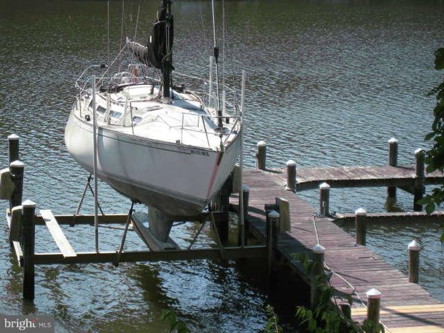 Wow!  What a deal, Over 100 ft of waterfront, private pier, 3 slips, boat lift, bulk headed on Mill Creek.  PLUS almost 3000 sq ft w/ large family rm w/brick surround f/p w/flu for stove. 12x20 Florida rm, kitchen w/custom cabinets, granite, hardwood. grand sized dining rm w/bump-out bay w/view. Master w/cathedral ceiling, sitting rm, skylights, private balcony. 2nd flr loft.  Brand new roof 2014