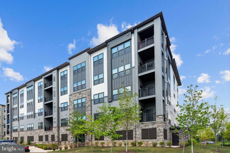 Move right in to this 2 years new, elegant, 3 bedroom or 2 bedroom with den, condo in Herndon/ Reston's exclusive luxury boutique building.  This complex offers the perfect combination of convenience with modern upscale living. There are EV charging stations and the extra convenience of an assigned parking spot in the garage.  A short walk takes you to the Herndon-Monroe Silver Line Metro Station, Harris Teeter and an array of of shopping and dining options. Situated on the 2nd floor, it offers easy access to the secure parking garage. The impressive open layout in this condo is designed to captivate.  The gourmet kitchen features sleek quartz countertops, soft close cabinetry and  high end stainless steel appliances. The wide plank flooring throughout the home adds a touch of contemporary elegance  seamlessly tying the the living spaces together. The spacious primary bedroom is flanked by a luxury bath with two sinks and a oversized walk-in shower.  The primary bedroom has two large closets. One walk in and one double. Relax on the peaceful balcony overlooking the beautiful common areas. Full size washer and dryer make laundry day a breeze. There is on site guest parking, a video call box for secure entry, Amazon Hub lockers, and a tranquil courtyard.  Reston Town Center is only 2 miles away. The community also boasts a paved walking  and running  path, a playground, a turf kickball field and  outdoor dining  areas complete with grills.  Sports enthusiasts will enjoy the practice tennis court and basketball court. This is urban living at it's finest, all within a peaceful urban setting.  You can lease this beautiful condo with or without the furniture.  

 $50 application fee per adult.   Apply through this link. https://apply.link/NICnGjY