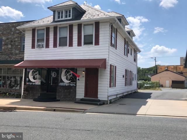 2,500+ sq. ft. mixed use building with 1250 sq. ft. main level, street entry commercial space, leased through January 31, 2026 plus two (2) second level walk-up residential apartments in the Town of Bel Air. B2 Zoning. through alley from Main Street to Bond Street. Three (3) parking spaces behind the building. Lease terms available in MLS documents.