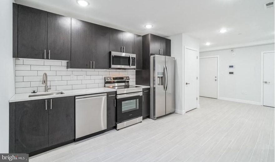 Welcome to 2411 N 7th St, Unit E – a stunning 2 bed, 2.5 bath apartment that combines modern elegance with comfortable living. This newly renovated gem boasts a sleek, open-concept layout featuring white shaker cabinets, pristine quartz countertops, and high-end stainless steel appliances. Enjoy the convenience of an in-unit washer and dryer, along with stylish luxury vinyl plank flooring throughout. The spacious master suite offers a private retreat with a spa-like en-suite bathroom, while the second bedroom includes its own full bath. Situated in a vibrant neighborhood, this home is perfect for those seeking both style and convenience.