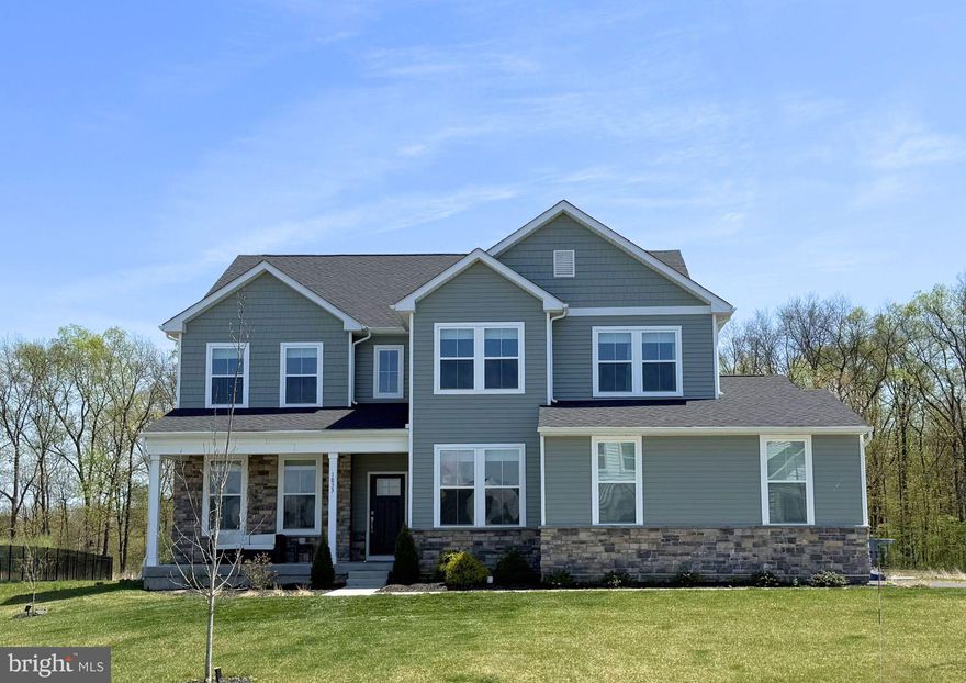 Huge Price Reduction. Sellers are relocating due to a job transfer and very sad to leave their beloved home. Now is your time to experience the perfect harmony of sophistication and serenity at 1033 Mariwill Drive, a gorgeous 4 bed, 3.5 bath home just built in 2024. Situated on a generously sized premium lot backing to trees with views of the dedicated open space, this Emerson floor plan model is the largest one offered by Lennar Builders with 4,500 square feet of finished living space, and is masterfully designed for versatility. As you enter you are instantly wowed with views of a grand, two-story great room anchored by a stunning two tier 60" gold chandelier and a cozy fireplace that serves as the heart of the home. The foyer also opens up into the formal dining room and an also a convenient home office tucked away from the hustle and bustle of the family. The main level flows seamlessly into a chef-inspired gourmet kitchen upgraded with custom cabinetry, sleek quartz countertops, huge center island with trendy pendant lights, designer tile backsplash, and a walk-in pantry.  This space extends into the builders upgrade morning room flooded with natural light and offering picturesque views of the quiet, peaceful backyard. Sliding doors off this room lead you out to the brand new enormous 28 x 20 ft high end composite deck with 25 year warranty and finished with low voltage lighting on the post caps and steps for amazing ambiance. This is an ideal setting for both lively entertaining and quiet morning reflections plus plenty of space to host your next big outdoor family gathering. Additionally located adjacent to the great room, the first floor offers extra flex space commonly used for an additional home office, tv/game room, or homework/craft area. Across is the drop zone/mud room with access to the two car garage. Finishing off this area is a large laundry room as well as powder room. The luxury continues on the upper level, where thoughtful design ensures privacy and comfort for everyone. On one end of the level are three spacious secondary bedrooms, all with large closets, and share a beautifully appointed hall bathroom with double sinks, quartz counters, oversized ceramic floor tiles, and a tub/shower combo. Head along the catwalk overlooking the two-story foyer with statement gold chandelier, and also the main living area and enter the primary suite which is a true private sanctuary. This retreat features an elegant tray ceiling, massive walk-in closet with custom made built-in closet organizers, and a spa-like ensuite bathroom with huge double sink quartz vanity, private toilet closet, oversized walk-in shower, and linen closet. Head down to the newly finished basement, carefully planned and built with high end finishes offering over 1,000 Sq Ft. of incredible  additional living space. This space is perfect for multi generational living or for your family and friends to spread out and enjoy. As you come down you will notice the LVP flooring running seamlessly throughout. There is a large great room area, separate home theatre room, and the most adorable custom children’s play house that’s built in under the stairs. Double glass paned doors lead into a room perfect for a home gym, while another separate room would make a perfect guest bedroom. Aside from the large unfinished space offering more than enough storage, there is an exceptional full bathroom with beautiful finishes wrapping up this level. Completing this designer home is a two-car side-entry garage, adding both convenience and curb appeal to the striking exterior. Additionally there is a carbon water filter and water softener, plus an exterior lighting package.  Whether you’re hosting in the grand heart of the home or enjoying the tranquility of your expansive lot, this home offers a lifestyle of effortless modern living.