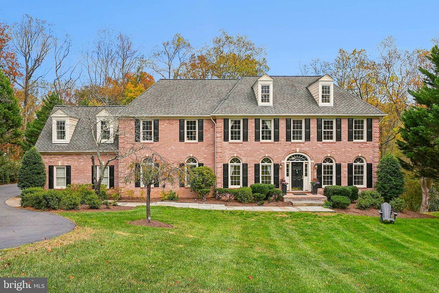 Tucked away on a quiet cul-de-sac in the heart of Great Falls, this stately all-brick residence offers over 7,000 square feet of refined living space on a picturesque  acre homesite bordered by a serene stream and lush woods. Deer, owls, and even fireflies create a storybook setting you’ll look forward to coming home to.

Inside, soaring ceilings and light-filled spaces set a grand tone. The two-story great room with dramatic windows flows seamlessly into the gourmet kitchen, featuring high-end appliances, a large pantry, and a generous island perfect for entertaining. A mudroom with custom built-ins connects to the three-car garage, adding both style and function. The main level also includes a living room, home office or optional bedroom, and a full bath, offering flexibility for guests or multigenerational living. Step outside to a two-level deck and  patio overlooking the peaceful natural setting—perfect for outdoor gatherings or quiet evenings watching the sunset over the treetops.

Upstairs, the primary suite is a true retreat with a spa-inspired bath and large walk-in closet. Two bedrooms share a Jack-and-Jill bath, while a spacious additional bedroom enjoys access to another updated full bath—ideal for family or guests.

The walkout lower level extends the living space with a wet bar, fitness area, bedroom and full bath, cedar closet, and ample storage. 

Combining timeless architecture, thoughtful updates, and the magic of nature, 903 Winstead St offers the best of Great Falls luxury living- in the Langley School District with easy access to the Village, Tysons, Dulles Airport, and in a Trick or Treat neighborhood! Pictures coming Saturday 10/25