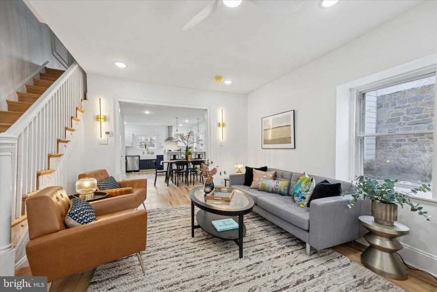 Modern Charm Meets Classic Elegance in the Heart of Overbrook! Welcome to 1824 Wynnewood rd, a beautifully reimagined twin,  nestled in one of Philadelphia’s most sought-after neighborhoods—Overbrook. From the stately stone exterior to the fresh, modern interior finishes, this home checks every box. Out front, enjoy your morning coffee on the covered porch with stone detailing—the perfect spot for relaxing or entertaining. And with a front lawn and charming curb appeal, this home truly stands out as city living with a suburban flare. Step into a bright and airy living space , where the open-concept main level offers seamless flow from a spacious living room with light wood flooring and a whitewashed brick, fireplace facade. This area is expanded into the dining area framed by custom wainscot molding and dual French doors that flood the space with natural light. The designer kitchen is a true showstopper—featuring two-tone cabinetry in navy and white, luxurious quartz waterfall countertops, sleek brass hardware, a farmhouse sink and a full stainless steel appliance suite. Pendant lighting above the breakfast bar and gold accents add just the right touch of elegance. Upstairs, you'll find three generously sized bedrooms bathed in sunlight with neutral tones, original wood flooring, and upgraded ceiling fans. The spa-like luxury bathroom features marble-style tile, gold fixtures, and a modern vanity. The third floor offers a private suite – perfect as a fourth bedroom, home office, playroom or guest quarters – featuring its own stunning full bathroom with marble-style tile and walk-in shower. The basement is clean, freshly painted, and houses a full laundry area with washer & dryer included with plenty of storage space.  Out back,  you'll find your private garage with driveway parking. Just minutes from City Avenue, public transit and parks —yet tucked away on a peaceful, tree-lined street. This home is truly turn-key and move-in ready, offering the ideal combination of design, space, and location. Schedule your showing today!