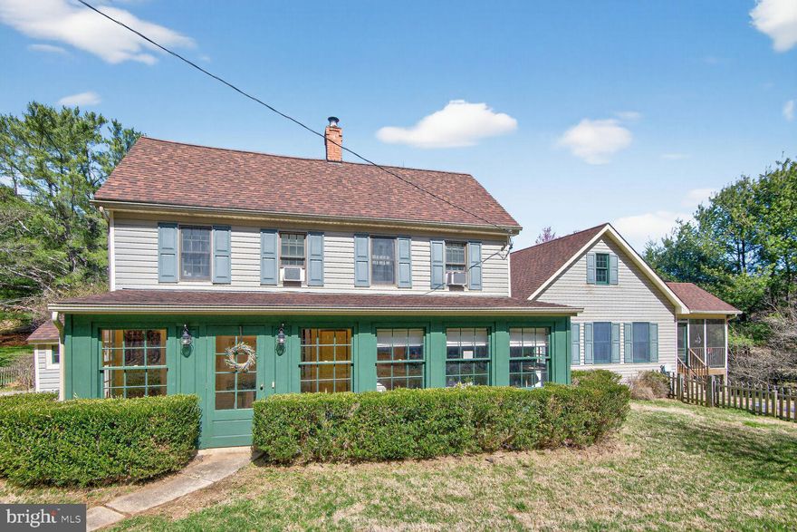 Welcome to a truly special farmette offering 5,136 square feet of living space, where timeless character meets thoughtful updates. The main house showcases old-world charm paired with modern comforts, creating a warm and inviting atmosphere from the moment you arrive. Adding even more versatility, the right side of the home features an in-law suite complete with its own family room, kitchen, bedroom with an attached primary bathroom, and a private screened-in porch—perfect for extended family, guests, or multi-generational living. 
The main level feels like something out of a romance novel, with entry into the vestibule used as a mudroom entry-way and beautiful hardwood floors that bring you back in time and highlight the home’s natural aesthetics. Enjoy quiet moments in the inviting living room—perfect for relaxing evenings or even a wonderful music room. The dining room is ideal for hosting gatherings, complemented by a quaint butler’s pantry perfect for displaying your finest spirits and serving pieces. Convenient main level half bathroom and laundry room and the kitchen carries authentic world charm with its natural interior walls and character-filled finishes, with attached sunroom perfect for preparing a cup of coffee or tea to start your day on the farm. The family room is truly a showstopper, featuring two walls of windows overlooking the picturesque farmette setting. Corner cabinet built-ins flank a cozy propane fireplace, creating the perfect place to gather. Attached is a large screened-in porch which extends the living space and offers a peaceful spot to sip your morning coffee and listen to the B-A-A of your Wooley friends.
Upstairs, you’ll find three spacious bedrooms and two full bathrooms in the main home, including an impressive primary suite designed for comfort and functionality. The large primary bedroom features custom built-ins, closet organizers, and a beautiful, vaulted ceiling, creating a light and airy retreat. The remodeled primary bathroom adds a fresh, updated feel while maintaining the home’s character. An additional walk-in closet on the upper level offers incredible flexibility and could easily be re-purposed into a home office, craft room, or kids’ playroom.
Walk-out lower level provides a large recreational room, abundant storage space, and an additional full bathroom—ideal for entertaining, hobbies, or flexible living. Even room for completing unfinished basement under the in-law suite for whatever you need! Exterior buildings provide many options!
With its generous space, storybook charm, and flexible living options, this unique farmette offers a rare opportunity to enjoy character, comfort, and beautiful surroundings all in one property.