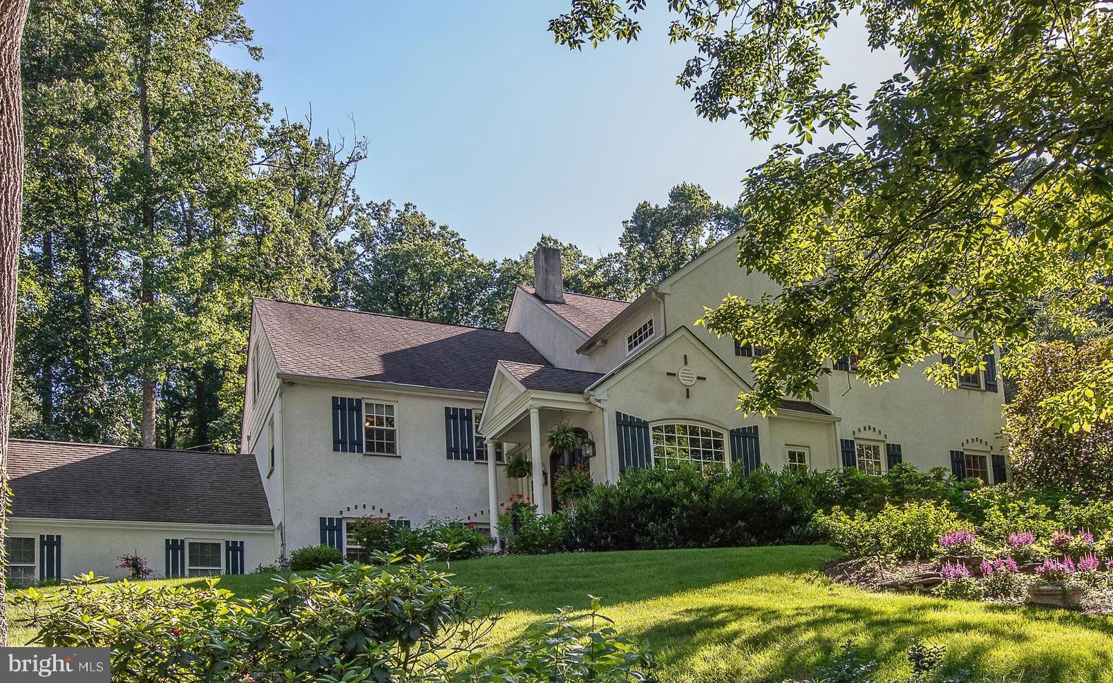 If you are looking for that exceptional and unexpected property in the award-winning Tredyffrin Easttown School District, this home is for you. As you enter through the beautiful wood-stained and glass double doors, you immediately feel as if you have stepped into a home tucked into the hills of the French countryside. Offering distinctive architectural features and designer touches throughout with a seamless welcoming flair. The bright & spacious open layout of the main floor with the fabulous Living Area features a full custom stone fireplace wall, exposed wood beams, & an exquisite Dining Area with hidden bar and concealed storage. Chef’s may only dream about this most amazing Gourmet Kitchen with an oversized 10+ ft Quartz center island, stunning custom cabinetry, high-end professional grade appliances, dual dishwashers, unique storage, a side bar serving area and twin double French doors opening to a beautifully landscaped and picturesque garden flagstone Patio. The outdoor space is a private oasis unto itself, and blends beautifully with the warm & welcoming indoor Living area creating a wonderful indoor/outdoor flow for entertaining family and friends.
Half a flight down from the main floor is the bright daylight Family Room, which is currently being used as an Office for a home-based business but could easily function as a kids play space with custom built-ins, Powder Room and door to the rear yard. There is a large Mudroom for storage and access to the front walk-way and attached two-car Garage.
On the upper levels you will find 5 Bedrooms and 4 Full Baths, all tastefully designed and updated. The Primary Bedroom is a superior space, airy and bright, with its own Sitting Room/Exercise Area, a large walk-in closet and a spa-like Primary Bath, with gorgeous Carrara marble, double sinks, a private toilet room and a steam shower to rejuvenate you. The additional 4 Bedrooms are roomy and inviting with 2 Bedrooms having their own en-suite Baths. The Laundry Room is featured on the same level as the 5th Bedroom. The large, finished Attic is cleverly designed as a kid space, great for hanging out with friends and having sleepovers. It also features an unfinished space for additional storage.
Great location with easy access to Devon Yards, downtown Wayne and Berwyn, Schools, R5 Train, as well as shopping and major highways. Fabulously designed with an unparalleled feel combined with low annual taxes for a property of this style (below $9,500 per year), this home is sure to delight the most discriminating buyer.