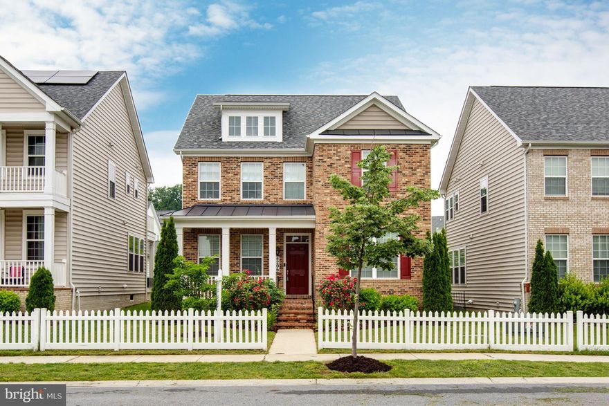 Welcome to 4206 Corams Lane! This charming Porch Front Colonial combines elegance with modern comfort. The open floor plan showcases wall moldings including crown molding, chair rail moldings while hardwood floors add a touch of warmth throughout. Gather around the cozy fireplace in the inviting living area. The gourmet kitchen is a culinary dream, featuring  tile backsplash, granite countertops, and a central island, perfect for meal preparation and casual dining. Office on main floor. The spacious primary bedroom is filled with natural light, huge walk in closet, double vanities! The finished lower level provides additional living space, including a possible 5th bedroom and full bath, ideal for guests or extended family. This home beautifully blends classic Colonial style with contemporary conveniences, making it an ideal place to create cherished memories.