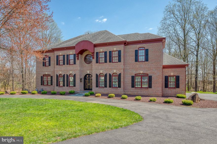 Welcome to 1505 Sunningdale Way, nestled in an exclusive neighborhood with mature trees and just moments from Maryland Golf and Country Club. This stunning all-brick, 6-bedroom, 7-bathroom residence with elevator offers a luxurious lifestyle with unparalleled amenities. A circular driveway leads to an oversized, heated three-car sideload garage, setting the tone for the grand entrance through the two-story foyer. Inside, exquisite craftsmanship is apparent with hardwood floors, crown moldings, and four gas fireplaces. The chef’s kitchen is a masterpiece, featuring granite countertops, a double sink, gas cooktop, double oven, undercabinet lighting, and a butler’s pantry. The adjacent family room boasts a tray ceiling, creating a warm and inviting atmosphere with a fireplace and views of nature. Designed for comfort and convenience, the home includes a whole-house audio system, recessed lighting, solid core doors, and an elevator. The main level offers a flexible office/bedroom, while the lower level impresses with a spacious recreation room, media room, wet bar with granite countertops, mini fridge, powder room and even a bedroom with an en suite bath (ideal for an in-law or au pair), and a walkout to the beautifully landscaped yard. New carpet adds to the fresh appeal of this level. Upstairs, the primary suite is a true retreat, complete with a sitting room, double-sided fireplace, tray ceiling, kitchenette, two walk-in closets, and a spa-like primary bathroom with a jacuzzi tub, dual vanities, heated floors, and a walk-in shower. Additional bedrooms are equally well-appointed, with a buddy bath and private en suite options. A separate laundry room with washer and dryer adds convenience. Thoughtful details like a chandelier with a lever for easy cleaning, rounded corner drywall, lighted closets, and both front and back staircases add to the home’s unique charm. This custom-built masterpiece is a rare find, offering a distinctive layout and luxurious touches throughout, situated on a three quarter acre lot. A bluestone walkway and patio enhances the home’s curb appeal.