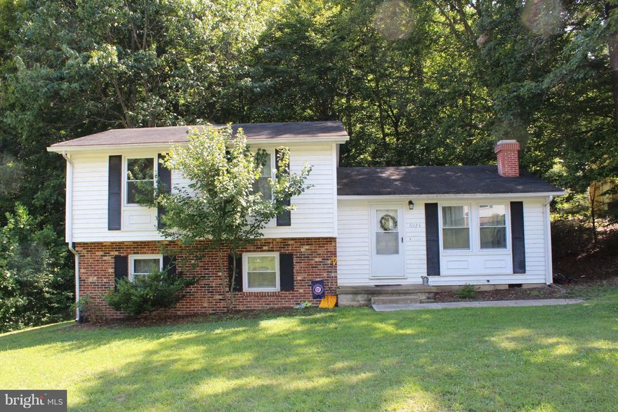 Charming bi-level home located in Loriella Park Estates.  Spacious lower level with half bath.  Charming living room w/fireplace.  Separate dining room.  Deck backs to wooded lot. 3 bedroom/ 2 full bath on upper level.