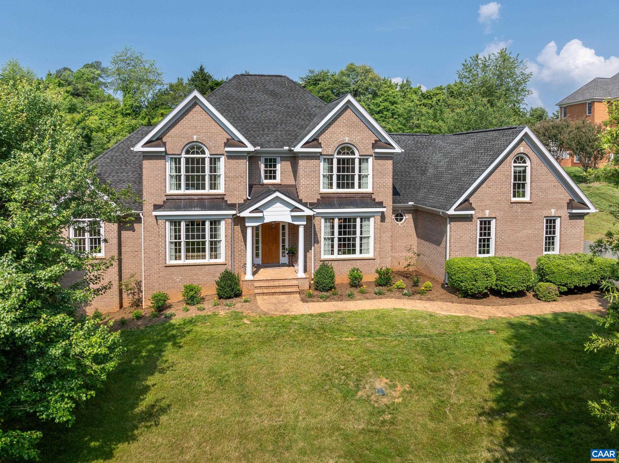 Exquisite Four-Sided Brick Home in Premier Established Community. Great location just 10 minutes from UVA and Hospitals, with easy access to I 64, wineries, and breweries. This custom home features main and second level primary suites, hardwood floors throughout the upper levels, and a fully finished walk-out basement with LVP flooring! The open main level is an entertainer's dream with a two story great room featuring a gas fireplace with built-ins , a gourmet kitchen with all new stainless steel appliances, cherry cabinets and granite, large formal living and dining rooms and a cozy breakfast nook. For flexible living this home boasts a primary bedroom suite on all three levels! The main level primary suite includes a gas fireplace flanked by built in book shelves. If you'd prefer your owner's suite upstairs, there is a cozy suite with a light filled bathroom with jetted tub and shower. Three additional bedrooms on the upper level share two full bathrooms. The finished walk out terrace level includes a large rec room, a bedroom with ensuite and gas fireplace and extra bedroom/home office - great for guests. 3 car garage, & new landscaped yard.,Cherry Cabinets,Glass Front Cabinets,Granite Counter,Fireplace in Bedroom,Fireplace in Great Room,Fireplace in Master Bedroom