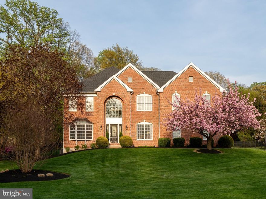 Welcome to 585 Brighton Way — A 4 bedroom, 3 full baths, & 2 half baths refined brick colonial offering thoughtful upgrades, & beautifully curated indoor-outdoor living in "Valley Forge Woods". Set on a beautifully landscaped lot, this residence combines timeless architecture with meaningful updates.  A grand two-story foyer introduces the home w/ hardwood flooring & an elegant staircase. To the right is the private office & to the left the living room-dining room combination, (this space can easily accommodate an unusually large table for holiday entertaining),…all filled with natural light. The layout transitions effortlessly into the heart of the home—an updated kitchen featuring custom cabinetry, a substantial center island, & generous prep & gathering space. The adjoining breakfast area is surrounded by windows & flows seamlessly into the two-story family room, where a floor to ceiling brick, natural gas, dramatic fireplace &  the two story wall of windows create a warm yet dramatic focal point. The private home office w/ custom built-ins offers a polished work-from-home setting, while the home’s thoughtful design provides both openness and defined spaces for everyday living and entertaining. The owners invested in an enlarged mud room w/ custom built-in lockers & a separate laundry room w/ custom cabinetry- both off of the 3 car garage w/ an additional door to the back yard. Upstairs, the primary suite is a true retreat, offering a spacious bedroom w/ tray ceiling a separate sitting room, & a fully renovated, spa-inspired bathroom complete w/ a freestanding soaking tub, oversized glass shower, dual vanities, & elevated finishes. The 3 additional bedrms are generously sized, two of the bedrooms share a Jack & Jill bathroom that has been renovated/updated. The third bedroom is serviced by the hallway full bathroom. The open hallway overlook enhances the home’s airy, architectural feel & features custom built in cabinetry . The lower level, finished basement, is designed for enjoyment, w/ custom wet bar & recreation space, ideal for entertaining, game days, or casual gatherings. This finished basement also features two more offices, a half bathrm, a play space, w/ storage closet for games, etc…. plus two, unfinished separate storage spaces. Outdoors, the property truly distinguishes itself. A custom hardscaped patio w/ seating wall, ambient lighting, and multiple entertaining zones creates a private, resort-like setting. The expansive fenced yard, mature trees, & thoughtful landscaping provide both beauty and privacy—perfect for quiet evenings or hosting guests.  The sellers have made significant investments in the home over time, including an updated custom kitchen, laundry, & mudroom renovation – all serviced w/ radiant heated floors, in 2007 ($178,000), a fully remodeled primary bathrm in 2024 ($52,640), & a Jack & Jill bathrm renovation in 2024 ($22,516). Additional major improvements include a finished basement in 2001 ($27,452), HVAC system replacement in 2014 ($23,500), &  a raised rear patio installation in 2006 ($22,965). The home also features a roof replacement in 2019 ($15,115), hot tub installation in 2024 ($12,773), & new second-floor carpeting in 2021 ($7,185), along w/ primary bathrm cabinetry updates in 2023 ($6,257). This home is part of a vibrant community that offers access to parks, walking trails, making it perfect for those seeking an active lifestyle. Enjoy the best of both worlds – a tranquil suburban setting, located just 10 mins to the Paoli Train which will take you north to D.C. & East to Phila & then straight to NYC. Just 10 minutes to downtown Phoenixville (voted #1 Best Small Town to live in America by Travel + Leisure magazine in 2025). Located across from the Phoenixville Country Club, 5 mins to the Phoenixville YMCA, hiking trails, Valley  Forge National Park is 3 miles away, & KOP Mall 7 mi. This home combines comfort, luxury, and long-term value . Welcome home!