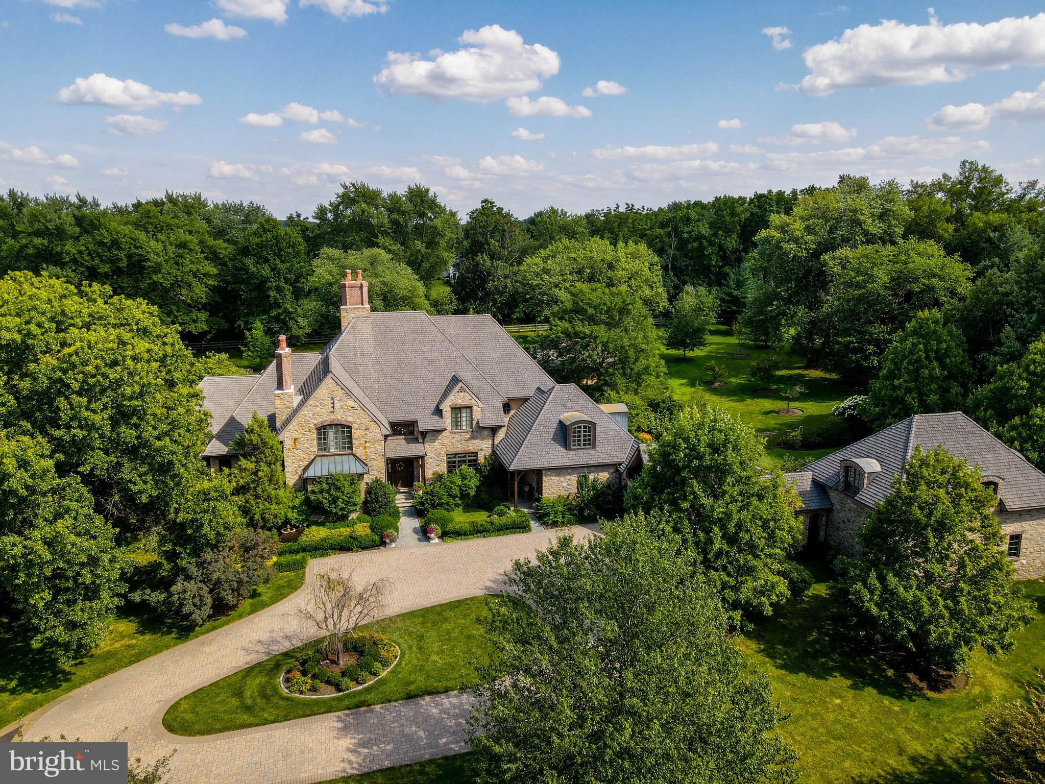 This idyllic luxury estate represents the finest in design, quality, artisanship and master craftmanship throughout and is absolute true move in condition. Designed by R.A. Hofmann and built by Parec, a true private gated masterpiece in Lower Gwynedd sited on 3.3 acres. This stately and sophisticated residence features 5 Bedrooms, 6.2 Bathrooms including an additional in-law suite/apartment with separate entrance over the detached spare garage (includes 5 garage bays total for the car enthusiast- 3 car attached and 2 car detached). In the heart of the house, a stunning new chef’s kitchen (2020) by Blue Bell Kitchens - truly Architectural Digest worthy and includes every bell and whistle imaginable (Top of the line - ALL appliances & fixtures). It was very recently installed less than 2 years ago with no expense spared. Truly, a sight to be seen. MAIN LEVEL level luxurious master bedroom suite with entrance to private blue stone terrace, spacious his and her closets fit for a king and queen, spa marble bathroom, marble gas fireplace and dramatic vaulted ceilings to complete this sophisticated space. The spacious great room off the kitchen includes soaring timber trusses with balcony and grand fieldstone fireplace. Also on the main floor: large entry foyer w/solid mahogany front door, spacious dining room, mahogany paneled study/library, sitting room, octagon four season sunroom w/grill overlooking rear yard views, mudroom w/built-ins leading to garage. Lower level is fully finished and offers a significant amount of additional space. It's completely moisture/water proof with the newest in architectural vinyl flooring. Other features include best of the best in high tech mechanicals including full radiant floor heat augmenting the dual boiler fan coil ambient air heating and cooling. Other special features include: Full house audio sound system, centralized lighting controls system, newer security system with camera’s, hardwood floors through out, radiant heated flooring, Pella windows, hand split cedar roof shingles with 25 year warranty an Terne metal roofing with copper sprouting. This private estate compound also includes a fabulous 62’ lap pool with waterfall spa, sprinklers and full pool cottage with gardener’s work space as well. A wonderful opportunity to enjoy first class living in Lower Gwynedd. The best of the best!