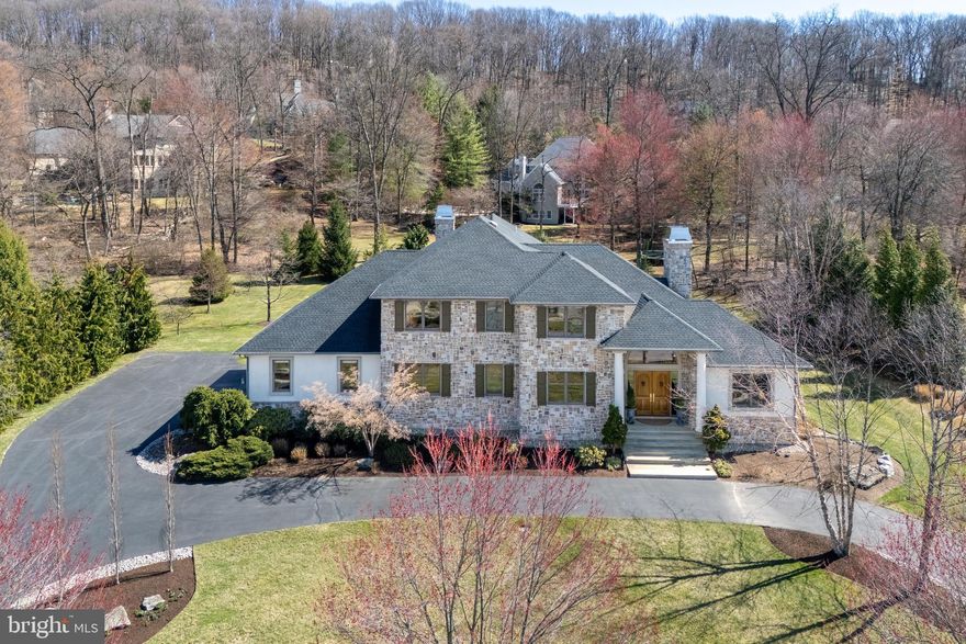 Nestled in the highly coveted Weyhill Woods neighborhood, this exquisite 4-bed, 6-bath home seamlessly blends everyday comfort with exceptional design. Soaring ceilings, custom millwork, and a dramatic staircase set a sophisticated tone. At its heart, the gourmet kitchen boasts luxe appliances, a butler’s pantry, bespoke cabinetry, and a stunning 3-inch marble island. The space flows effortlessly into a charming breakfast nook, cozy keeping room, and an enclosed den, both warmed by their own gas fireplaces—perfect for intimate gatherings. A built-in wet bar enhances the home’s effortless elegance, seamlessly connecting the main living areas for refined entertaining. A private, first floor guest ensuite is ideal for visitors or multi-generational living, while two dedicated home offices offer elegant workspaces. Upstairs, the primary suite is pure indulgence with two spa-inspired bathrooms and custom walk-in closets. Two additional ensuite bedrooms complete the upper level. The finished lower level extends the home’s versatility, offering a rec room, fitness area, dedicated workshop, and abundant storage. Outdoors, the professionally landscaped grounds impress with a backyard patio, soaring covered front porch, and circular driveway leading to an attached three-car garage—all enhancing the home’s striking curb appeal. Perfectly positioned near top-rated schools and the picturesque Saucon Rail Trail, this residence offers an unparalleled lifestyle of luxury and convenience.