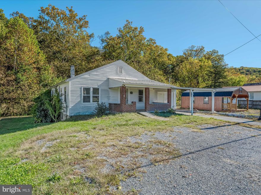 Looking for your next investment opportunity? Ever dreamed of owning your own business? Well then, welcome to 685 Henry W Miller Blvd! This property is located in the heart of Paw Paw - a perfect location for any local business! This was formerly a bakery and as you are walking through you will find remnants of such. The main room still features two nice sized display cases, cabinets for all your storage needs, and a prep sink. The sitting/dining room comes with two sets of tables and chairs. A large storage room with a utility sink is located down the hall. The kitchen is located in the back and is equipped with an industrial sink, industrial oven, and industrial stove + range, there is even still a mixer to get you started! The converted garage provides another large storage space/room. The covered front porch and carport are perfect locations for outside seating. The covered back porch offers views of the woods and a small stream  providing just the location you need to be able to step outside and take a break from your flourishing business! This was once a four-bedroom home so you could potentially convert it back to such if this would better suite your needs.  Other added bonuses include the original hardwood floors located throughout most of the building, an attic that you can access via stairs from the back hallway, a full unfinished basement (including under the garage), and a water filtration system. What are you waiting for? Schedule your showing today!
