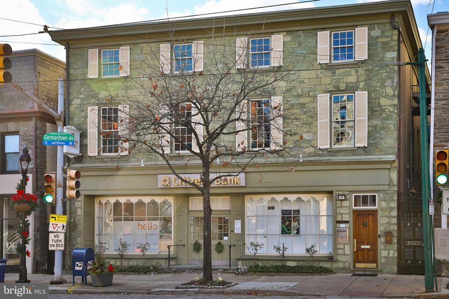This unique opportunity isn't offered often. In fact, it has only had 2 owners in 70 years since known as "The Huston Dry Goods Emporium."  This is your chance to own a piece of Chestnut Hill History in THE premier "Top of the Hill" location! Positioned prominently in the Chestnut Hill Business District at the intersection of Germantown Avenue & Bethlehem Pike gives it the highest exposure. This unique, multi use building of over 9,300 Sq Ft,  (circa 1860),  offers 4 apartments (3-2 BR, 1 -1 BR)  a large store front retail space, and two generous sized offices (+/- 1182 SqFt ea)  with private entrances in the rear annex building. (added 1922)  According to historical records,  its' green serpentine stone facade with stone sills and wood cornices, is shared by only one other building on Philadelphia.   Adding to its' convenient accessibility,  it sets atop the Chestnut Hill West Regional Rail line leading directly to Center City and 30th street.  Chestnut Hill is rich with a diverse offering of restaurants, local businesses, and homes ranging from cottages to mansions!  Chestnut Hill was featured as one of the charming residential neighborhoods on Good Morning America's "Main Street USA" series! All units are currently leased with staggered expirations.  Since current owner has historically kept lease rates low, the income is well below market value and  even well below a  conservative income projection! The location is vibrant with a blend of modern amenities and historic gems, with  added appeal for its' walkability to the beautifully expanding Woodmere Art Museum, The Morris Arboretum & Gardens, the splendid Wissahickon Valley Park, Chestnut Hill Hospital and Chestnut Hill College. This commercial corridor location allows open ended possibilities for significant  increased profitability. See attached statement sheet with lease and utility information.  As leases expire, this will allow a variety of alternate options for each unit.  It is your time to approach this creatively and plant roots in this growing community.  Showings must be set through listing agent and bank can be shown only during banking hours. Dimensions and taxes are based on city records and may not be accurate. These should be verified by buyer.