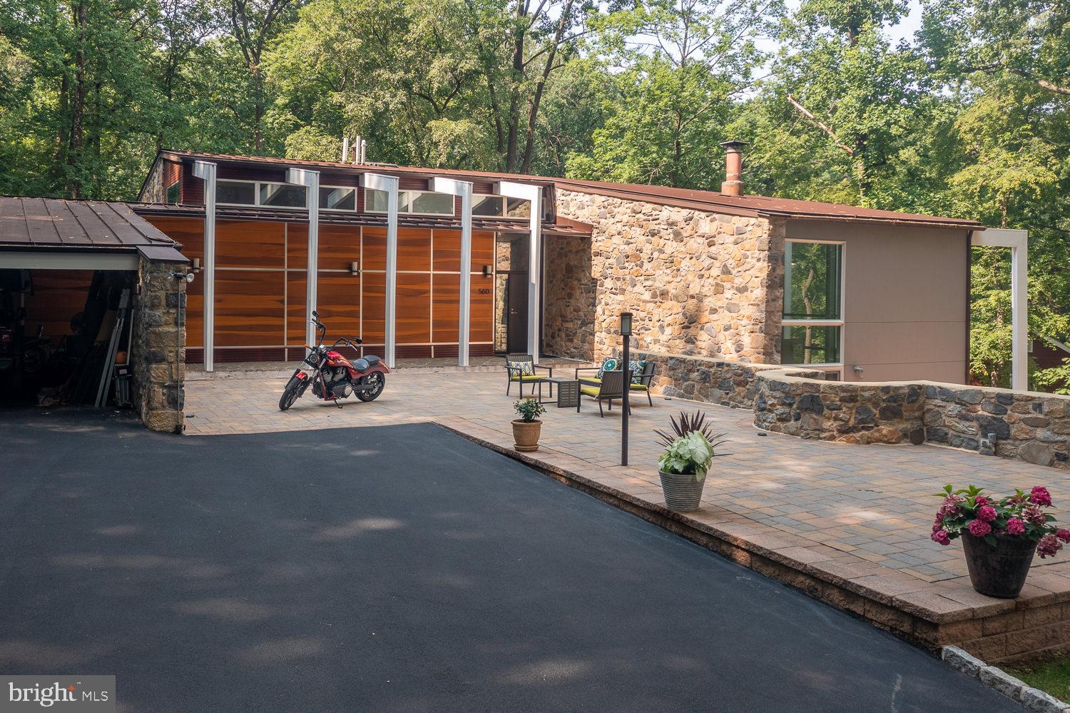 Rare opportunity to own a significant mid-century modern home designed by modernist architect Kjell A Ingebrigtsen of the Vincent G Kling and Associates architecture firm. This 4 bedroom, 3 bath home has the qualities of a modern classic, with a light-filled interior that seamlessly connects to its beautiful outdoor setting. The home immediately makes a statement with its floating stairs passing over a reflecting pool as one enters the main living space. The dramatic living room features walls of fieldstone and glass. The organic lines of the freestanding fireplace draw the eye upward, highlighting the double height space. A private stone-walled courtyard is accessed from the living room. The south and east glass walls of the dining room offer views and access to two decks, facilitating al fresco dining. The kitchen overlooks a stone-walled family room and bar area. Thoughtfully designed outdoor spaces include a terraced pool, outdoor kitchen, courtyards surrounded by stone walls, and multiple decks and balconies.
The home is located in the highly rated Tredyffrin/Easttown School District. The King of Prussia Mall, King of Prussia Town Center and multiple shopping centers are within a 5-minute drive. Also within 5 minutes are Wegmans, Whole Foods, and Trader Joe's. Valley Forge National Historical Park is just 3 miles down the road.