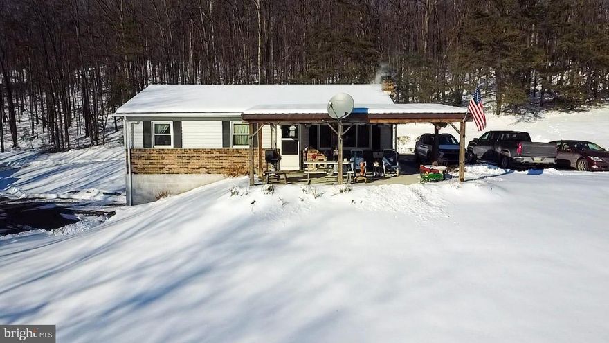 This is it! A property that has it all and country living on 10.02 acres.  Enjoy the rural setting with peace, privacy, and wide open space located in Pennsylvania's beautiful countryside.  The  charming property is zoned agricultural and offers 3 bedrooms, an updated bath, a country kitchen, large living room with a fabulous view,  and a covered front porch on the first level. This porch has a foundation for finishing as future interior living space. The lower level has a full basement with integral garage, workshop, a laundry area,  a commode and sink to use as a half bath, and  space for future finishing potential.  Heat it all efficiently and economically with the wood stove, perfect for cozy winters and country living.  Four mini-split units are installed for cooling and heating comfort.
The expansive acreage with several outbuildings is ideal for farming, gardening, livestock,or recreational use with plenty of space to enjoy nature, start a homestead, or simply relax in the quiet setting and enjoy your best life!