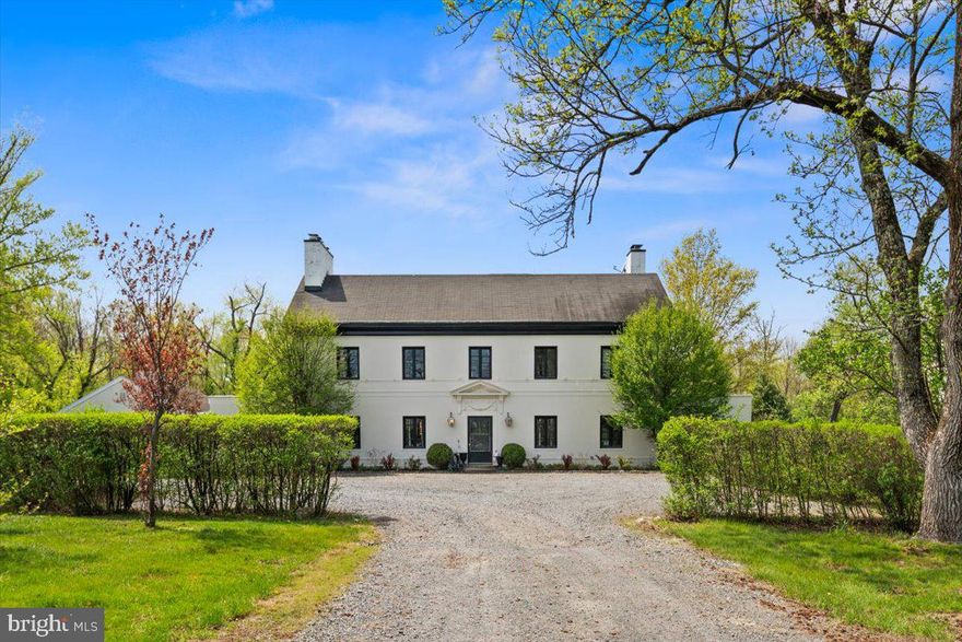 A timeless 1920s manor estate showcasing old world charm seamlessly enhanced with modern conveniences, set on 13 private acres just minutes from downtown Princeton. A long, tree lined driveway leads to this elegant three-story residence offering six bedrooms, including a luxurious primary suite with a wood burning fireplace, private balcony, and an exceptional custom walk-in closet.

This gracious manor features four wood burning fireplaces located in the kitchen, library, living room, and primary suite. Original architectural details including pocket doors, French doors, refined millwork, and bluestone terraces evoke worldly craftsmanship and enduring character. The home is filled with ideal east to west light, creating warm and inviting living spaces throughout.

The newly designed kitchen incorporates today’s modern amenities while honoring the home’s historic elegance. Features include an oversized center island with quartzite countertops, Kohler farmhouse sink, Thermador appliances, custom millwork, and a wood burning fireplace. The kitchen opens to the living room with built in bookcases, custom lighting, and French doors leading to the sunroom and library, making the home ideal for both everyday living and entertaining.

A breezeway has been converted into a custom mudroom with beautifully designed Pottery Barn style organizational cubbies, perfect for bags, jackets, shoes, and sports equipment. The main level carriage house apartment offers a private entrance and separate utilities, making it ideal for an extended family situation, home business, gym, guests, or domestic help.

Outdoor amenities include a serene swimming pool and an accompanying pool house with a full bathroom, kitchen, and changing room, offering an idyllic setting for summer relaxation. The grounds also feature a three-car garage 22x48 with attic storage,concrete floor and electric- exceptional privacy, and potential for subdivision.

Recent updates include a three zone Lennox hybrid HVAC system, two instant tankless hot water heaters, and refinished hardwood floors. Located within a top-rated school system, close to private schools, and offering a Princeton mailing address, this exceptional estate is rich with history, character, and beauty. A rare opportunity where friends and family will love to gather.