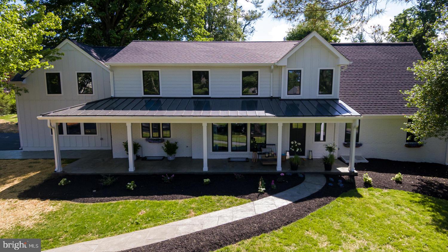 This chic and sophisticated modern farmhouse is set on a beautiful flat 3/4 acre lot in desirable Villanova. Fully renovated by Pradelli Homes in 2020, this stunning home features a white board and batten exterior with black windows and black metal roofs. Spanning approx 5200 sq feet of finished living space, 6 bedrooms 5 full baths and a first floor powder room. Beautiful modern farmhouse kitchen in black and white with a shiplap fireplace, huge island for entertaining, Thermador appliances, Rohl kitchen faucet, farmhouse sink, walk in pantry/butlers pantry, Carrera quartz countertops, built-in microwave, and cabinet paneled refrigerator and dishwasher. This is the perfect home for entertaining. The open floor plan flows effortlessly. Multiple seating areas, three fireplaces, and a brilliant black dining space with floor to ceiling wainscoting. The first floor en suite is perfect for guests. Master suite with vaulted ceilings, reclaimed wood beam, and beautiful chandelier is spectacular. Master bath with his and hers vanities. The walk in shower with stand alone tub is stunning! The master closet is a blank canvas. $2000 credit at closing so that the buyers can create the closet of their dreams. There's an additional en suite on the second floor. This home boasts a total of three en suites. The second floor also features two additional bedrooms, full bath, and laundry room. First floor mudroom off the two car garage also feature a laundry. The basement is approx 1200 sq feet of impeccably finished living space with a living room, gas fireplace with shiplap and reclaimed beam mantle, bedroom, full bath, storage, utility room, and walkout. New flooring throughout with wide plank Shaw flooring in the main living spaces. Beautiful new black windows throughout. New doors. New HVAC. Updated Plumbing. Updated electrical. New high end light fixtures and plumbing fixtures throughout. This is new construction with reasonable taxes on a beautiful lot. Driveway freshly paved. New stamped concrete front porch and walkway, Freshly landscaped. The back yard is waiting for your personal touch....pool, hardscaping, endless.