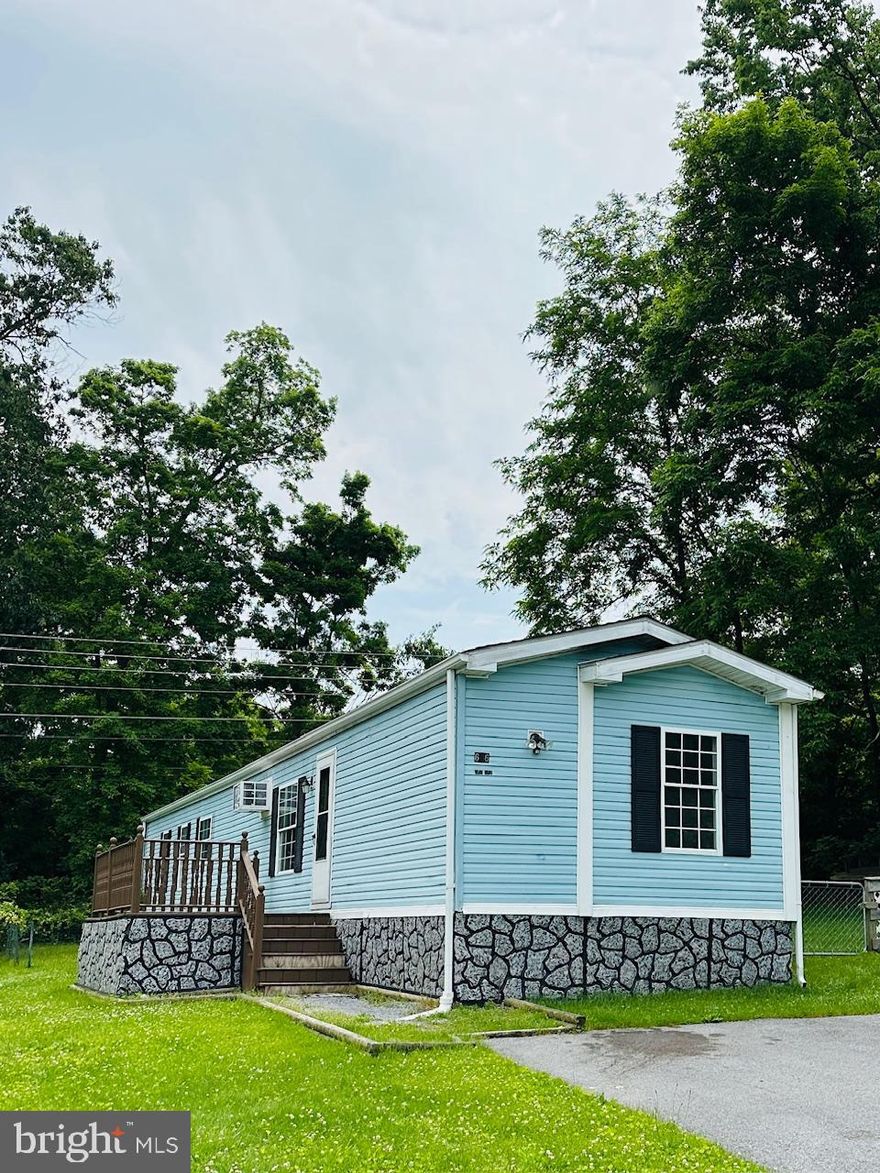 Check out this mobile home situated on a beautiful, private lot!! This home features two bedrooms, including a spacious primary suite with a private full bathroom.  The kitchen offers ample cabinet space, a convenient island, and a dedicated dining area.  Recent upgrades include fresh paint, carpet, vinyl flooring, new stove, washer, and dryer.  The bright and open living room boasts generous built-ins for extra storage.  Enjoy the fully fenced rear yard with added privacy, perfect for relaxing or entertaining. Two car parking pad.