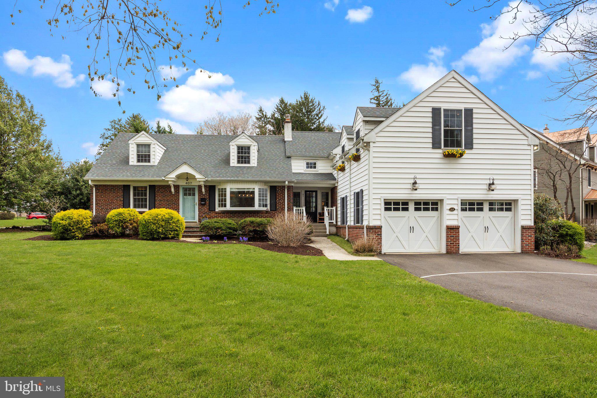 Don't miss this expanded Cape Cod style home, brimming with charm, and offering an abundance of space to accommodate today’s lifestyle. Perfectly situated in Historic Newtown Borough, this residence is just a short stroll from quaint boutiques, acclaimed restaurants, the wonderful Newtown Theatre and community parks.
Sunlight pours through every window, highlighting the rich hardwood floors and showcasing lovely views of mature trees and vibrant gardens. At the heart of the home lies the thoughtfully updated kitchen featuring custom white cabinetry, elegant soapstone countertops and farm sink, stainless steel appliances, and stylish pendant lighting. Just off the kitchen, the inviting family room is anchored by a cozy gas fireplace flanked by a wood mantle, and custom built-in shelving to display your books, art and cherished keepsakes. The spacious dining room, enhanced by a wide bay window, provides a perfect setting for gatherings both large and small.
A convenient main floor bedroom, with a generous walk-in closet, is adjacent to a full bath—an ideal space for guests or multi-generational living. A private home office rounds out this level, offering a quiet retreat for remote work or creative pursuits. A spacious two car garage, accessed via the mudroom, offers plenty of room for outdoor gear and equipment.
On the second level, the expansive primary suite features a walk-in closet and beautifully updated en-suite boasting luxurious custom tile finishes, a large walk-in shower and dual-sink vanity. Three additional well-proportioned bedrooms and hall bath are included on this level, in addition to a dedicated laundry room and charming alcoves offering flexible space for reading, workouts, and hobbies.
The partially finished lower level is designed for fun and function, offering spaces for, media, music, and recreation, along with a separate area for workshop and storage. Step outside to your private stone patio—perfect for sipping your morning coffee, hosting a summer BBQ, or enjoying lawn games as the sun begins to set. Impeccably maintained and move-in ready, this exceptional home invites you to enjoy the best of Bucks County living in one of its most picturesque towns. Conveniently located close to major highways, train stations, and airports for your next vacation getaway!