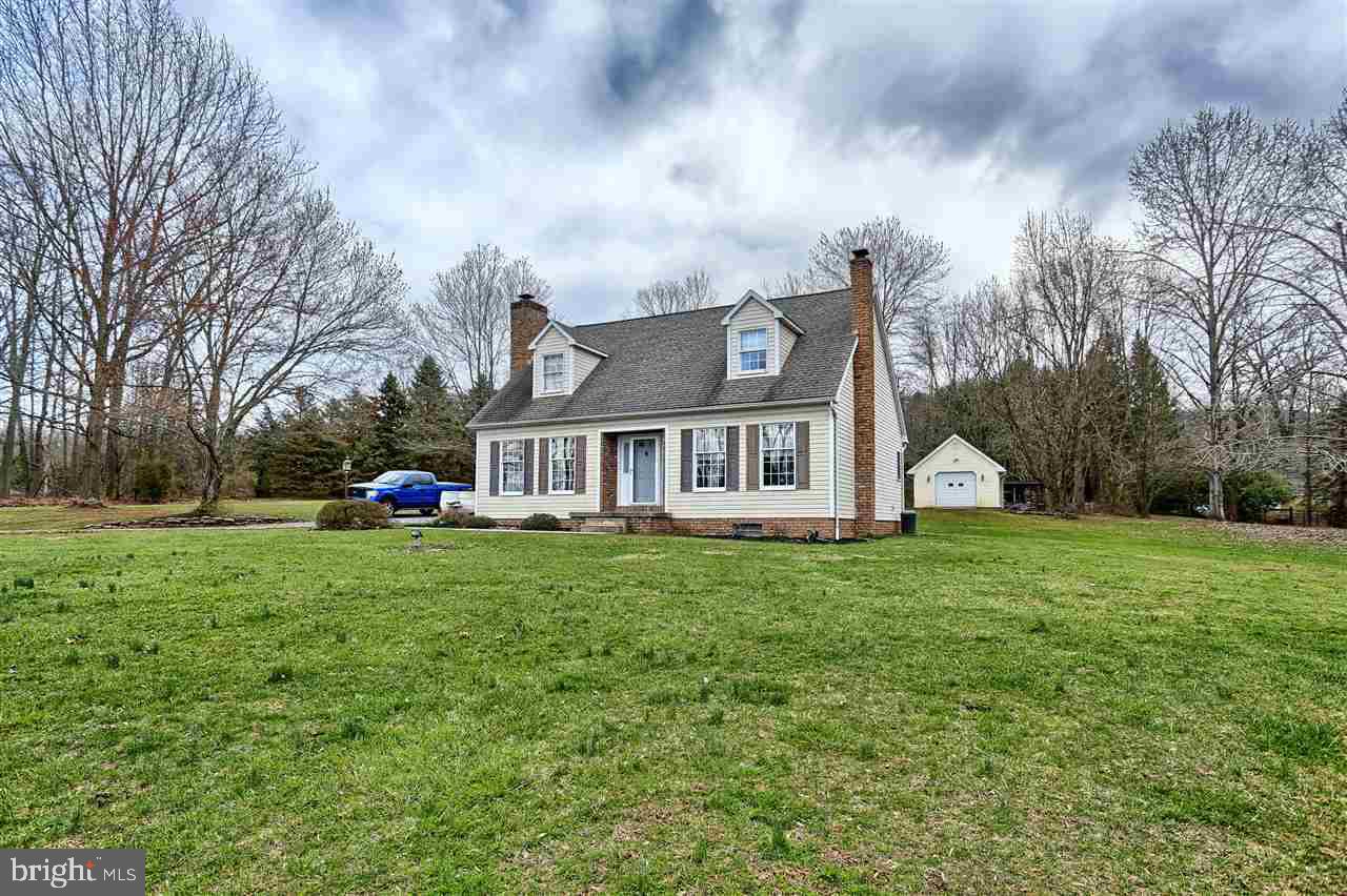 Enjoy your privacy cape cod home with 7 + acres in Dover schools. 4 Bedroom & 2 bathrooms, Living room with wood fireplace and Dining room. Office has brazilian wood floors this room could be turned back into 1st floor bedroom & bathroom access behind closet. Huge deck off of Dining Room. buyer can get Public Water access. Huge 40x30 pole barn behind house with detached garage. Wood stove in basement. One owner home with pride of ownership.