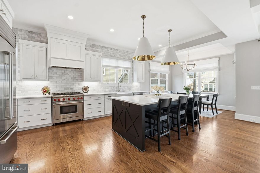 Luxurious 2018 Lyon Village residence offers the opportunity to live in a "new" home without the stress or price tag of building. Situated in one of North Arlington’s premier neighborhoods, the home provides unbeatable convenience to Washington, D.C., and the vibrant Clarendon Corridor. With four finished levels over 5643 square feet of living space, it boasts 6 bedrooms and 5.5 baths, delivering an unmatched lifestyle of comfort, elegance, and modern living. >>

A gracious foyer welcomes you inside, flanked by a formal dining room and a sunlit study, perfectly positioned for elegant entertaining and everyday functionality. Throughout the home, high-end Roman shade window treatments complement the rich hardwood floors, detailed millwork, and abundant natural light. >>

The heart of the home unfolds in a stunning family room anchored by a sophisticated gas fireplace and enhanced by elegant, coffered ceilings. The adjacent gourmet kitchen is a true showpiece, featuring top-tier appliances including a Sub-Zero refrigerator and 6-burner Wolf range, with an expansive center island that flows seamlessly for entertaining. A thoughtfully designed butler’s pantry houses a walk-in pantry and a dry bar with a beverage refrigerator, offering a perfect connection back to the formal dining room. A stylish powder room and a mudroom with soaring ceilings and custom built-ins complete this level. >>

The upper level offers four generously sized bedrooms. One includes a private ensuite bath, while two additional bedrooms share a beautifully appointed Jack and Jill bathroom featuring marble countertops, dual sinks, and built-in storage. The primary suite serves as a serene retreat, highlighted by elegant tray ceilings, two walk-in closets, and a spa-inspired bath with marble floors and countertops, dual vanities, a luxurious walk-in shower, and a freestanding soaking tub—an oasis of calm and comfort. A well-appointed laundry room with checkered tile flooring and ample storage completes this level. >>

The top floor features an expansive bedroom with National Cathedral views and an attached full bath. The finished lower level expands the living space with a large recreation room, an additional bedroom and full bathroom, and a versatile bonus room well suited for a home gym, office, or hobby space. >>

Outdoors, the charming front porch and private backyard provide the perfect setting for relaxing, entertaining, or everyday living. A detached one-car garage offers practical convenience while blending seamlessly with the home’s style. >>

This remarkable residence offers the rare opportunity to enjoy like-new construction, elevated finishes, and timeless design, all in one exceptional Arlington home. **Showings by appointment only.**