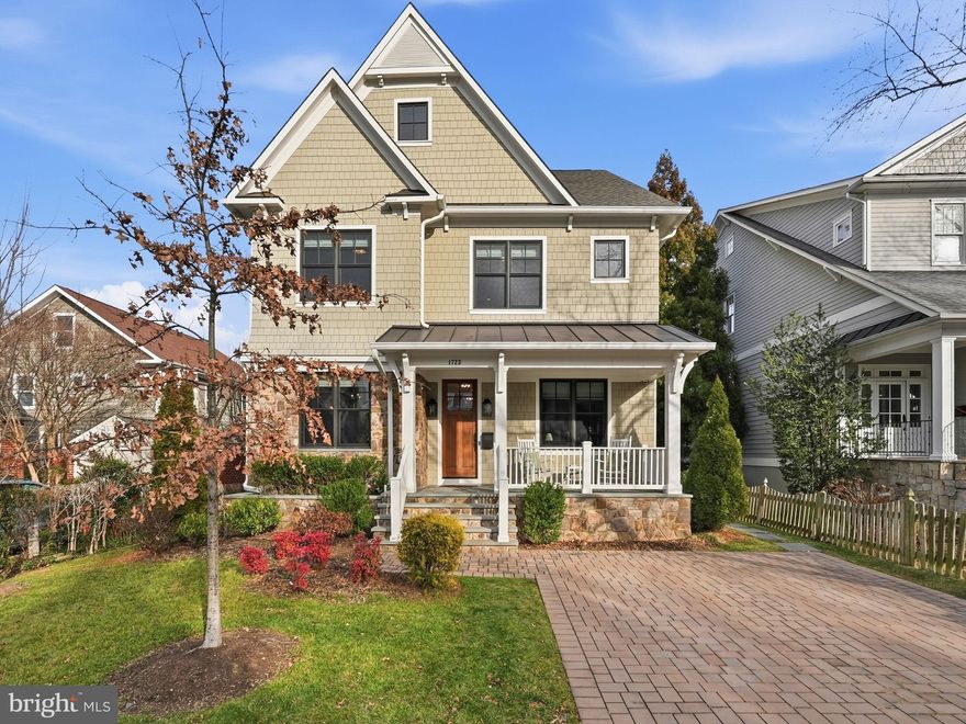 Built in 2018 yet presenting with the polish of new construction, this exceptional Lyon Village residence offers refined luxury living across 5,397 finished square feet. Situated in one of North Arlington’s premier neighborhoods, the home provides unbeatable convenience to Washington, D.C., and the vibrant Clarendon Corridor. With four finished levels, it boasts 6 bedrooms and 5.5 baths, delivering an unmatched lifestyle of comfort, elegance, and modern living. >>

A gracious foyer welcomes you inside, flanked by a formal dining room and a sunlit study, perfectly positioned for elegant entertaining and everyday functionality. Throughout the home, high-end Roman shade window treatments complement the rich hardwood floors, detailed millwork, and abundant natural light. >>

The heart of the home unfolds in a stunning family room anchored by a sophisticated gas fireplace and enhanced by elegant, coffered ceilings. The adjacent gourmet kitchen is a true showpiece, featuring top-tier appliances including a Sub-Zero refrigerator and 6-burner Wolf range, with an expansive center island that flows seamlessly for entertaining. A thoughtfully designed butler’s pantry houses a walk-in pantry and a dry bar with a beverage refrigerator, offering a perfect connection back to the formal dining room. A stylish powder room and a mudroom with soaring ceilings and custom built-ins complete this level. >>

The upper level offers four generously sized bedrooms. One includes a private ensuite bath, while two additional bedrooms share a beautifully appointed Jack and Jill bathroom featuring marble countertops, dual sinks, and built-in storage. The primary suite serves as a serene retreat, highlighted by elegant tray ceilings, two walk-in closets, and a spa-inspired bath with marble floors and countertops, dual vanities, a luxurious walk-in shower, and a freestanding soaking tub—an oasis of calm and comfort. A well-appointed laundry room with checkered tile flooring and ample storage completes this level. >>

The top floor features an expansive bedroom with National Cathedral views and an attached full bath. The finished lower level expands the living space with a large recreation room, an additional bedroom and full bathroom, and a versatile bonus room well suited for a home gym, office, or hobby space. >>

Outdoors, the charming front porch and private backyard provide the perfect setting for relaxing, entertaining, or everyday living. A detached one-car garage offers practical convenience while blending seamlessly with the home’s style. >>

This remarkable residence offers the rare opportunity to enjoy like-new construction, elevated finishes, and timeless design, all in one exceptional Arlington home. **Showings by appointment only.**