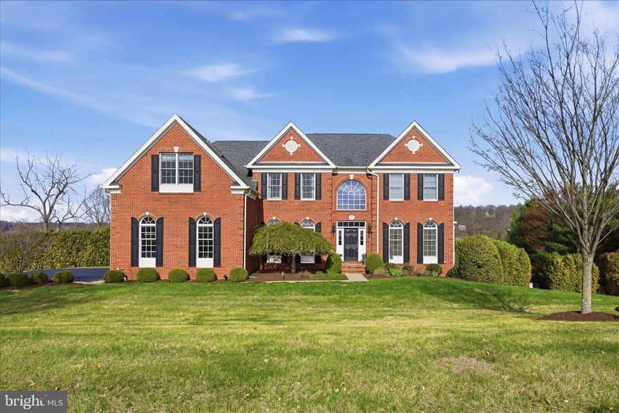 Experience resort‑style living in this beautifully maintained Waterford Ridge home, offering sweeping mountain views and a stunning backyard oasis with a screened porch overlooking the sparkling pool. The 3.10‑acre property features vibrant perennial gardens, mature bushes, large decorative boulders, and a 4‑board fenced half‑acre with wire covering. Laurel bushes along the front provide natural, elegant privacy.
With over 5,000 sq. ft. of finished space, the home blends luxury and comfort. Highlights include mahogany hardwood floors, a dramatic two‑story family room with gas fireplace and tinted windows, a custom‑cabinetry library, and a gourmet kitchen with granite counters, cherry cabinetry, double ovens, and an oversized refrigerator. Step from the kitchen onto the screened porch and deck with ceiling fan, custom lighting, and synthetic flooring—perfect for enjoying the views and easy access to the pool. 
The serene primary suite features a sitting room with custom built‑ins and breathtaking views, along with a spa‑inspired bath offering a jetted tub, skylight, towel warmer, and lighted defrosting mirror. Three additional spacious bedrooms include one with an ensuite bath. Laundry areas are conveniently located on both the main and upper levels. 
The walkout lower level is ideal for entertaining, with a recreation room, gym, full bath and a fully equipped home theater with tiered seating, premium projector and sound, and leather recliners. Outside, a stamped concrete patio with stone firepit provides the perfect gathering space. Recent upgrades include a whole‑house generator, landscape lighting, new furnace, new carpet, fresh paint and a new pool pump and filter. There is also an electric chandelier winch for ease of cleaning and maintenance. Meticulously cared for and move‑in ready, this home offers exceptional everyday living in a truly beautiful setting.
Perfectly positioned for convenience and tranquility. Enjoy sweeping countryside views and exceptional privacy while staying close to everything you need. Downtown Leesburg is just 8 miles away, and Dulles International Airport is an easy 26 mile drive—offering the ideal blend of rural charm and modern accessibility.