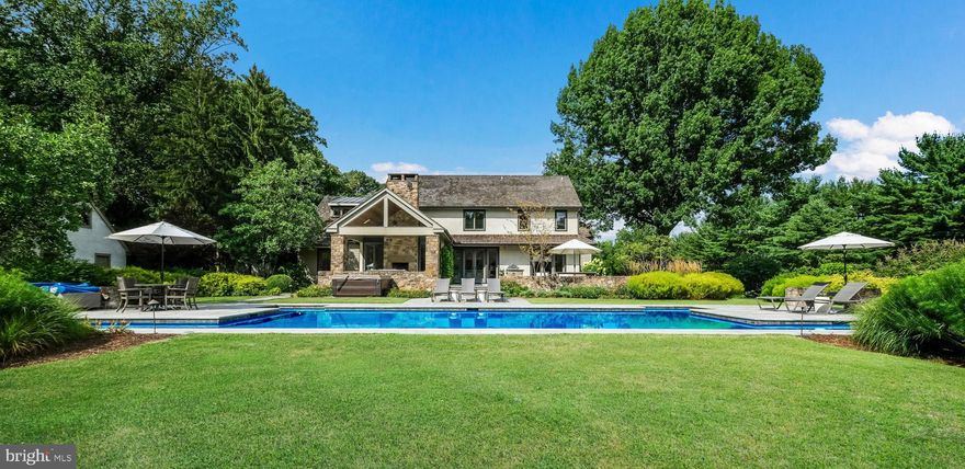 Exclusive Contemporary Estate with Sophisticated Design on 5.6 Acres in Prestigious Bucks County. Discover unparalleled luxury in this Exquisite Contemporary residence set along the idyllic Ash Mill Road in Buckingham. This Custom-Built Estate boasts four bedrooms and four and a half baths, offering the epitome of privacy and exclusivity.  Enter up the long drive to find a lavish in-ground pool with a lap lane, a state-of-the-art wellness studio, courtyard parking, a three-car garage, and a serene meadow. Originally rebuilt in 2007 under the visionary guidance of renowned architect Lynn Taylor, the current owners have meticulously elevated the home with extensive renovations by the acclaimed Jarrett Vaughan Builders. Step through the welcoming Front Porch into a serene Living Room, where white oak floors, a raised paneled wall, and floor-to-ceiling windows allow natural light to flood the space. The Gourmet Kitchen is a chef’s paradise, featuring Calcutta honed marble countertops, island and backsplash, a Wolf six-burner cooktop, a Wolf wall oven & steam Oven, a Subzero refrigerator, a newly designed pantry with Soapstone counters & Backsplash w/ Subzero refrigerated drawers, nugget ice maker and Wine Bar. The Kitchen opens to a Family Room with a cedar vaulted ceiling with a stone floor-to-ceiling Fireplace with raised hearth and a built-in Banquet! The elegant Dining Room, ideal for entertaining, connects seamlessly to the Kitchen and the Ipe deck, which includes a charming water feature. An architectural highlight is the intentional "glass hallway" leading to the Game Room, a cozy family space with a wet Bar, TV with surround sound (included), and powder room. Above the Game Room is a private Bedroom Suite with a full bath, perfect for guests, an au pair, or in-laws. This Wing of the home with its versatile first-floor family room is perfect for multigenerational living.  Downstairs, a newly renovated Mudroom features floor-to-ceiling cabinetry, a washer/dryer, a crisp white Full Bath, and a one-of-a-kind floating bench. Adjacent to the Kitchen, a tasteful First-Floor office with built-ins and windows offers a perfect view of arriving guests. Up the Open Staircase, you’ll find the serene Primary Suite, complete with a raised paneled wall and a tasteful sitting area. The luxurious bath features a soaking tub and a dramatic tile shower. The highlight of this Primary suite is the bright white Dressing Room with a quartz center island, thoughtful built-ins, storage, and a dedicated makeup area, making getting ready a daily delight. The Upper Level also includes a gracious, light-filled landing, two additional bedrooms, and an updated hall bath with custom tile. The Lower Level boasts a second home office, a workout area, a theater with an Epson Projection TV & reclining theater couch (included), plus a music studio/multipurpose space.   Outside, meander down a bluestone walkway to a private Wellness Studio featuring cedar half-penny shiplap, cedar trusses and beams, a polished concrete floor, skylights, and preserved stable doors and sliding barn doors. This unique outbuilding offers versatility as an office, design studio, music studio, or meditation space. The Outdoor Living spaces are unparalleled, with bluestone patios, a covered outdoor space with a stone fireplace, a dramatic saltwater in-ground pool with a 25-yard lap lane, built-in grill, stone walls, a new hot tub, and breathtaking views of the expansive sky and Buckingham Mountain in the winter! The sellers have collaborated with Dear Garden Associates over the years to create stunning gardens, add perimeter trees,  a wildflower meadow, stone walls, & Belgian block parking courts. The three gar garage features an EV charging station, epoxy floor, and additional storage above. Brand new air conditioning and a new generator.  In the winter, warm radiant heat is throughout the whole home! Premiere location with one of the most coveted addresses in Bucks County.