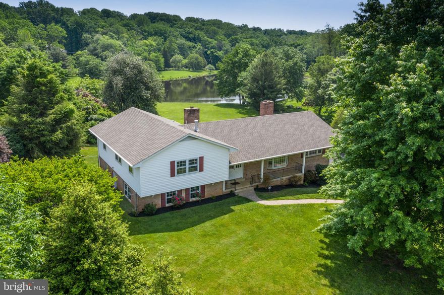 One of kind home and lot SET BETWEEN THE COMMUNITY BARN AND THE COMMUNITY LAKE - TOTAL OF 1.09 ACRES - in a UNIQUE EQUESTRIAN COMMUNITY! This custom built  home is within minutes of all conveniences  but in an AMAZINGLY PEACEFUL AND IDYLLIC SETTING in the community of Moneys Corner.  You will want to be home all the time, and you'll have the space and the views to enjoy it!  This property is being sold with an ADDITIONAL BUILDABLE HALF ACRE LOT (2729 Calkins) that sits between the home and the community lake!  Views out the front of the house include the Community Barn, pastures and riding circle.  The 14 stall barn with electricity,  running water and tack house only charges $60/mo for stall fees!  You can keep an eye on your horse from your kitchen:)  Out back and from your large, dual level deck are GORGEOUS LAKE VIEWS - nature lover's delight all year long!  Perfect for enjoying sunrises, barbeques, entertainment galore, or quiet evenings all to yourself!   And so private too!  The house itself is VERY IMPRESSIVE and DECEPTIVELY LARGE (Over 3000 Sq. Ft. Finished plus 420 Sq. Ft. Unfinished) , and within a TOP SCHOOLS PYRAMID - OAKTON HS!   You will be amazed by the charm and solid, spacious feel!  All of the rooms are generously sized and flow well throughout the home.  Enter from the front porch to the wide Foyer and enjoy a bright and open Living Room with STRIKING REFINISHED HARDWOOD FLOORS.  You'll love the floating wood burning fireplace that centers the room.  From there you'll get a glimpse of the NEWLY UPDATED EAT-IN-KITCHEN!  The Sparkling White Quartz countertops, new light LVP flooring, and the big bay window with a lovely view will make you smile:)  The kitchen also opens to the Dining Room on the back of the house, which boasts another bay window that takes advantage of those gorgeous views.  A fabulous place to enjoy special occasions and entertaining!  What's even more amazing is the huge Family Room off the Kitchen with another brick hearth Fireplace, this one gas!  Oh the hours of enjoyment you'll have here!  Note that there's also a SECOND STAIRCASE to the downstairs from here, making unloading groceries and getting in and out of the house from the OVERSIZED TWO CAR GARAGE super easy.  From the Family Room you walk out to enjoy your deck:)  Upstairs you'll find three generously sized bedrooms, all with those newly refinished hardwoods and ample closet space, and two updated baths.  The Primary Bedroom easily holds a king sized bed, and boasts a walk-in closet as well as extra closet space!   The NEWLY UPDATED PRIMARY BATH includes a sparkling white quartz double vanity, a large walk-in tiled shower, all new tile flooring, lighting and mirrors!  It's beautiful!  The Hall Bath has been EXTENSIVELY UPDATED as well, and features the same sparkling white quartz counters and dual sinks, and new lights and mirrors!  Downstairs you'll find two very large Bedrooms and ANOTHER UPDATED FULL BATH .  One of the bedrooms walks out to the side yard, and lends itself well as an additional Rec Room.  But wait!  There's more!  Go down one more level to a freshly painted UTILITY/WORKSHOP/HOBBY SPACE that connects to the  huge Garage!   Outside offers a wide variety of enjoyment as well!  There's a good sized area on the side with  high fencing - perfect for a garden or protected space for your (big) pooch:)    Lovely landscaping and views all around the home!  You won't believe you're within minutes to the Dulles Toll Road, Reston Town Center, Silver Line Metro stops, and every convenience you can imagine!  And the schools?  Highly rated Crossfield Elementary, Rachel Carson Middle School, and Oakton High School!  Moneys Corner  consists of 44 acres, 21 of which are lovingly cared for common grounds.  Community stocked lake, charming gazebo, and a dock great for fishing!  You really CAN have it all!!!   Come see this property soon -  you don't want to miss it!