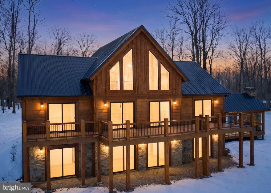 Panoramic Lake views in the Bray Run community, just minutes from Deep Creek Lake, state parks, and more! Built in 2025, this 4-bedroom, 4 full bath, 2 half bath log style chalet sits on 0.59 acres of peaceful, quiet serenity. Cathedral and beamed ceilings rise above an open layout filled with abundant natural light. Two stacked-stone fireplaces anchor the main living area and the lower-level family room. Granite counters, stainless appliances, and a custom island define the kitchen. A loft overlooks the main level, adding flexible living space. Outside, a deck and stamped-concrete patio lead to a covered pavilion with a wood-burning fireplace for year-round use. Central A/C, forced air heat, well water, public sewer, and a metal roof complete the package. If you’re looking for a new home that’s just off the beaten path, yet still offers easy access to everything Deep Creek Lake has to offer—this one needs to be on the list… Call today for details!