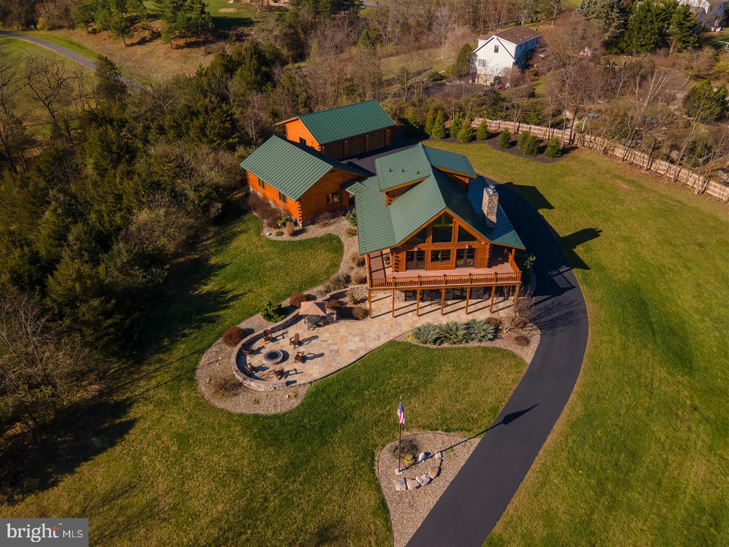 CREEKSIDE SPLENDOR - 10.46 acres. Today, working remotely has become a reality. Located approx. 90 miles from both Baltimore, MD and Washington D.C. , this property is located ideally to make the commute once or twice a week. Enjoy working in this tranquil setting the other days of the week! You will also find yourself less than 15 miles from Whitetail Ski Resort! Your own personal piece of paradise, offering tranquility, beauty, and quality craftsmanship. This is the perfect place for respite, while still living comfortably with all the modern day conveniences. With access to the Conococheague Creek as well as Antrim Township Park, step out your front door for (kayaking and tubing, fishing, swimming, mountain biking trails, walking, hiking and running trails, 18- hole frisbee golf course). A short walk through the woods and you have arrived in the park with all it has to offer. The property is adjoined to Martin's Mill Bridge, the second longest covered bridge in Pennsylvania, built in 1849. Positioned on the highest peak of the property, the home boasts views from the all glass east side of the home. You will catch stunning views of the sunrise, the creek and of the 100+ year old Sycamore trees . The custom log home is constructed of air-dried logs and features customization throughout the entire home. (Windows cut to order, Honduran Cypress Wood Floors, Hickory Cabinets, Stone Fireplace Mantel, Live Edge wooden steps cut and kiln dried, custom made sconces and light fixtures, bar top made from chicken coup in N. PA, bar shelves made from support beam from Martin's Mill Bridge, ALL Solid Wood Doors, handmade railing and bannister caps, professional window treatments and landscaping. Don't let this remote feeling property fool you... The entire house is wired with a commercial grade alarm system with 8 cameras on the property, a SONOS sound system inside and outside, CAT5 wiring, 400 amp service in the main house and 100 amp in each garage and the barn. The barn has a new roof, new wiring, new windows, a new concrete slab floor, and a farm well. High Speed Internet is accessible at the house, along with an AT&T mini Cell Tower. Walk inside the home through one of it's 6 doors, and you are immediately met with a cozy and comfortable feeling. The Great Room with it's vaulted ceilings and Fireplace (real wood-burning insert) joins nicely with the gourmet kitchen with it's oversized granite island. The primary bedroom features a high speed vault built into the wall. The bedroom leads to the primary bathroom featuring a completely custom-made shower. The customized closet is located within the bathroom with a bolted safe to secure valuables. Upstairs you will find 2 additional bedrooms and a custom built-in hickory desk in the lofted area. The lower level features a custom built bar, an entertainment area, and a real wood burning stove installed in a custom made arch enclosure. You will also find a full bathroom, a bonus room , and the operations (unfinished) room. This operations room houses all the mechanics of the home, including SONOS system, alarm system, gaming system, HVAC, and water treatment. The double doors on the lower level walk out to a large flagstone patio and entertaining area, equipped with a wood burning tier 4 smoke reduction fire pit, a professionally installed flagpole with lighting, and wall lighting when dark. There are two, 3 car oversized garages on the property. The heated garage closest to the house is connected to the home by a breezeway and is equipped with a 220 AMP electric car charger. The second garage has polished concrete floors, has a mix of cherry and oak tongue and groove boards on the walls, and has a metal ceiling. Cable is run to the garage and it has a ductless HVAC system. The possibilities for this second garage are endless. CHECK OUT THE MUST WATCH PROPERTY VIDEO to see just how beautiful this home and property is and all it has to offer!!!