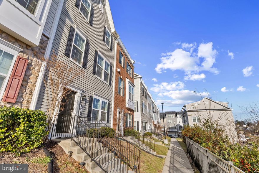 Inviting Kenyon model end-of-row townhouse by Richmond American Homes offering 3 bedrooms, 2 full bathrooms, 2 half bathrooms, and 2,285 finished square feet in conveniently situated Elkridge Crossing. The walkout entry level features a spacious family/recreation room with access to the 2-car garage. Upstairs, the open-concept main level impresses with hardwood floors, crown molding, and abundant natural light. The living room is anchored by a cozy gas fireplace framed by built-in bookcases, while the sunlit dining area offers balcony access through sliding glass doors. The beautifully appointed eat-in kitchen boasts granite countertops, stainless steel appliances, pendant lighting, 42-inch cabinetry, a pantry, a custom tile backsplash, and an island with breakfast bar seating—perfect for everyday meals or entertaining. A powder room completes this level. The upper level offers three plushly carpeted bedrooms and two full bathrooms, including the inviting primary suite with a walk-in closet and a spa-inspired bath that includes a dual-sink vanity, a gorgeous tiled shower, and a private water closet. The top level showcases a versatile loft with a powder room, a laundry closet, and access to the expansive rooftop deck—an ideal outdoor retreat. All of this is set in a convenient location near Patapsco Valley State Park, Rockburn Branch Park, shopping, dining, entertainment, and major commuter routes.