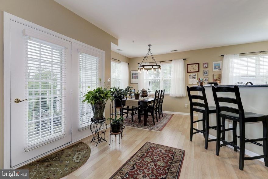 55+ great open top floor corner unit w 9  ceilings & sunny southern exposure! Lots of windows & light. Gourmet kitchen with granite counters, wrap around breakfast bar & stainless steel energy efficient appliances. Pergo wood floors thru hallway, living & dining areas. Two bedrooms w ensuite bath & a den/office. Great balcony! Parking spot 11 in garage & storage unit too! Short stroll to shops & restaurants!