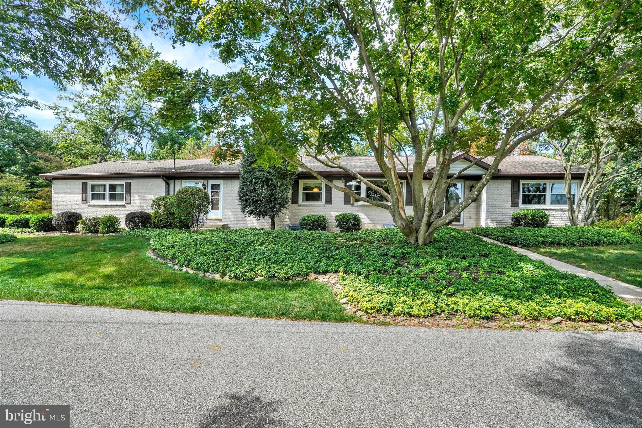 Welcome to this immaculately maintained split-rock rancher, gracefully nestled on a pristine, landscaped lot adorned with vibrant gardens and mature shade trees. Timeless in design and exceptional in care, this sprawling residence offers refined living both inside and out. Step inside to discover gleaming hardwood floors that flow throughout generously sized rooms, each filled with natural light. The heart of the home is a beautifully appointed eat-in kitchen, featuring rich granite countertops, sleek black appliances, under cabinet lighting, and ample cabinetry—perfect for everyday living and effortless entertaining. A thoughtfully designed laundry/mudroom offers convenience with a half bath, direct access to the front yard, interior entry to the finished two-car garage, and a breezy transition to the inviting rear covered porch. From here, step onto the expansive TimberTech vinyl deck and take in the serene beauty of the backyard—ideal for quiet moments, intimate gatherings, or outdoor entertaining. The walk-out lower level is a true retreat, boasting a spacious family room anchored by a floor-to-ceiling, split-rock gas fireplace. A door leads to a large patio area, seamlessly blending indoor comfort with outdoor charm. A full bath and an abundance of storage space complete this level with versatility and function. This home also offers peace of mind with numerous quality updates, including replacement vinyl tilt-in windows for easy maintenance and energy efficiency, an updated central air system, gas furnace, and water heater—all ensuring year-round comfort. The architectural shingle roof adds both durability and timeless curb appeal, reflecting the thoughtful care invested throughout the property. The finished, end-load two-car garage is a nice find, offering a 10 ½’ ceiling and insulated doors—ideal for hobbyists, storage, or workspace. An 8x14 Shed is also located on the property. Tucked away in a picturesque, off-the-beaten-path setting, this exceptional home offers peaceful, scenic living while remaining just minutes from everyday conveniences, Shrewsbury, and the Glen Rock exit of I83—making it an ideal location for York or Maryland commuters. AGENTS - Please read Agent Remarks.