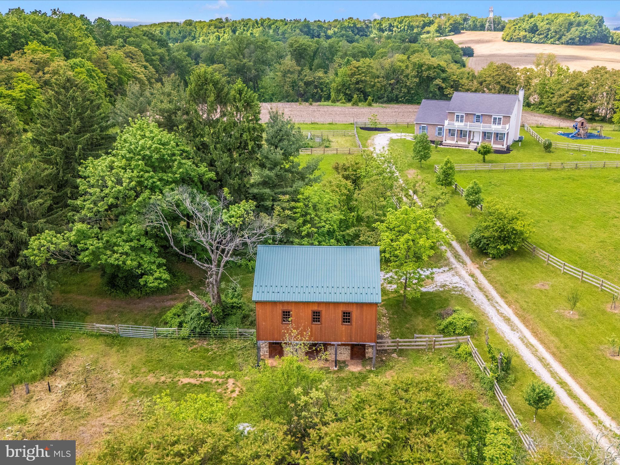 This special 40 acre property is ideal for those looking for a country lifestyle with modern conveniences. Whether for equestrian use, farming or simply enjoying the great outdoors, the blend of functionality and natural beauty will not disappoint.
The timeless style of the brick colonial home that is centrally located on the property offers a seamless flow from the living to the kitchen and dining areas. The primary suite with walk in closet and spacious bathroom as well as the 3 additional bedrooms and full bath complete the second level. The lower level is unfinished and offers a high ceiling height that awaits your ideas.
A standout feature of this gem is the charming bank barn that was recently meticulously restored with the quality craftsmanship of an Amish barn specialist. The attention to detail while adding charm and utility is a true art and it is on display with this barn. There are currently 4 stalls in the lower level of the barn. The spacious hay loft could be for storage or stylish rustic entertaining.
Several fenced paddocks and run in shed suggest horses, cattle, sheep, goats, alpaca or llamas+. The property is studded with fruit trees as well as ornamental and mature hardwoods. Nature is literally at your doorstep. Birds and wildlife are yours to enjoy from your porch as well as by way of the many trails that meander throughout the property.
The absence of an HOA holds appeal for those seeking autonomy over their property. Ag transfer tax will apply if buyer does not continue agricultural use. Property has no subdivision potential. AS IS sale. Price reflects the need for cosmetic improvements in the house.
