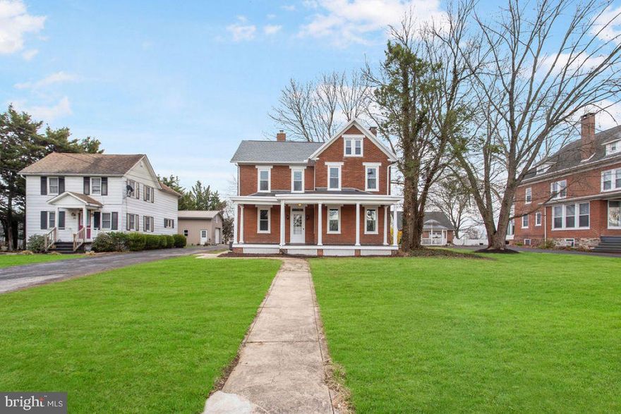 The moment you drive up to this beautiful, recently updated, brick colonial home with lots of road frontage, you're going to fall in love.  The big front porch welcomes you home and is just waiting for your chairs to enjoy the upcoming spring and summer weather.  Step inside and you'll be brought back to a time where homes were filled with character and charm, starting with the open staircase in the foyer area.  To the right is the living room with brick gas fireplace with built in surround bookcases.  The dining area leads to the kitchen with brand new stainless steel appliances and gas cooking.  The sitting room can also be used as an office, den, play room or whatever you want it to be.  The laundry and full bath are off of the kitchen and it has a convenient utility sink!  Upstairs, the 2nd floor has 3 big bedrooms with brand new carpeting and another full bath with a massive shower stall.  The 3rd floor has another bedroom with hardwood floors and it also gives you the flexibility of being another office or den etc.  The floored attic and basement gives you lots of room for storage.  Out back there is lots of yard to run around in, put in a play set, or make a firepit area and it overlooks farmland.  The detached oversized 2 car garage and lots of additional parking is extra convenient.  This beauty with  tons of living space will not last long.