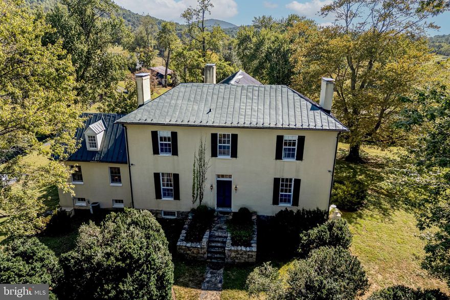 Carrington Farm, set on 50 private acres in bucolic Delaplane, is steeped in history and now on the market for the first time in 85 years. Built in 1830 by John Marshall, the fourth Chief Justice of the United States, as a wedding gift for his youngest son Edward Carrington Marshall. Inside, the home retains the character and grandeur that only a residence of this vintage and provenance can offer, characterized by grand-scale rooms with 11-foot ceilings, Jefferson windows, uniquely intricate fireplaces and millwork, and countless enchanting period architectural details preserved. The airy floor plan allows for splendid social flow within the home and outdoors to the ethereally beautiful and thoughtfully sited private grounds bordered by exquisite stacked stone walls from the home's original garden allée, many 150-200 year old plantings and trees, and serene surrounding pastoral and mountain views. Original bank barns still stand on the property, and the guest house which once served as a schoolhouse for the Marshall family children offers a glimpse into everyday life of the 19th century. New propane furnace installed and septic system work completed in September 2025.